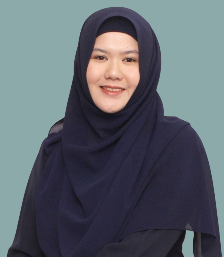 Portrait of a Ramitha, wearing black clothing, against a light blue background.