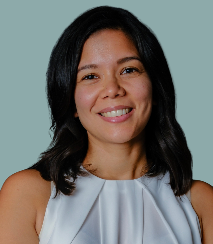 A photo of Nadia, against a light blue background.