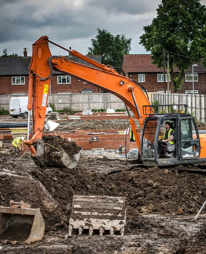Groundworks specialists preparing foundations on a construction site