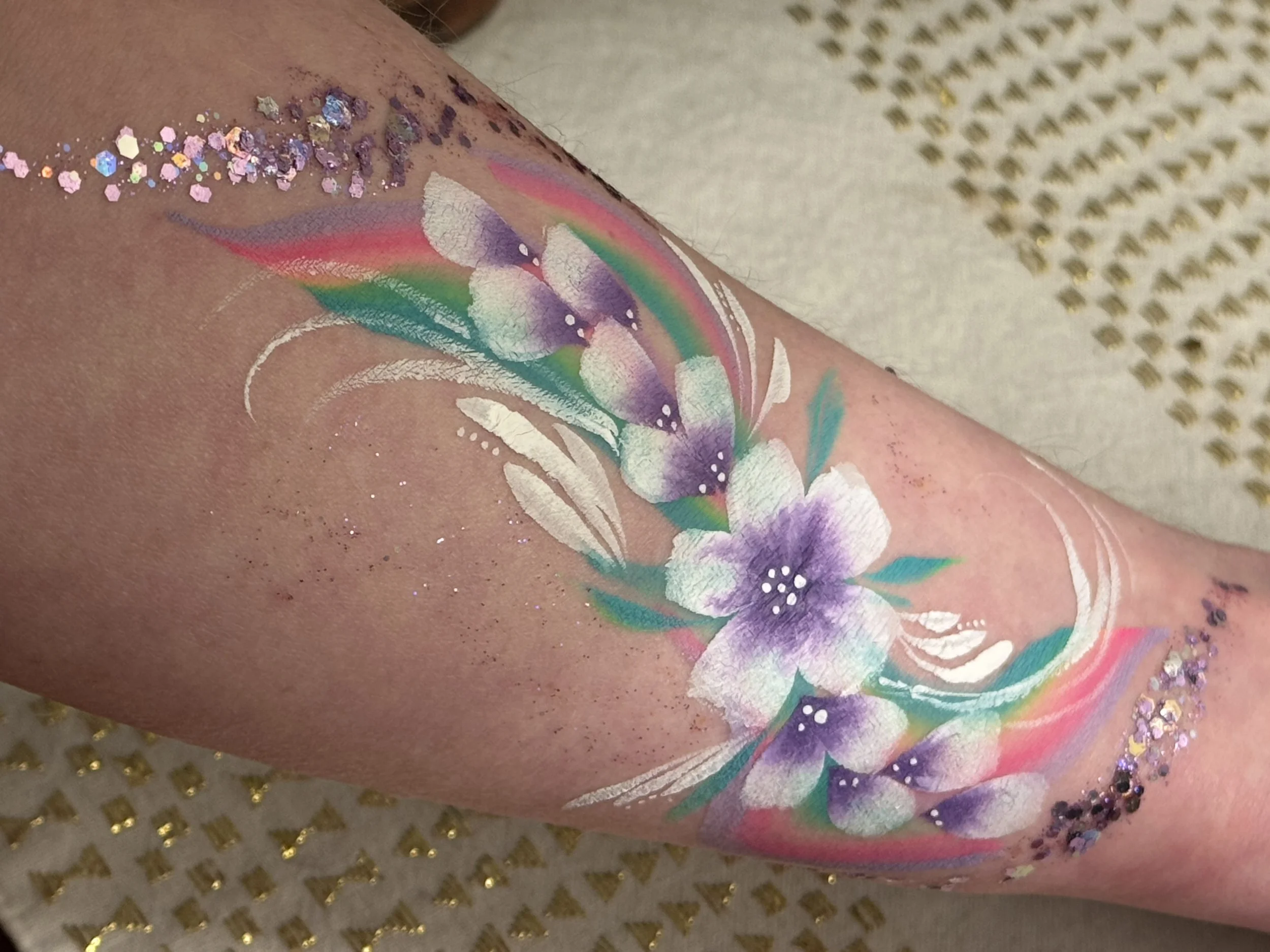 A glittery floral arm paint design perfect for kids and grown-ups.