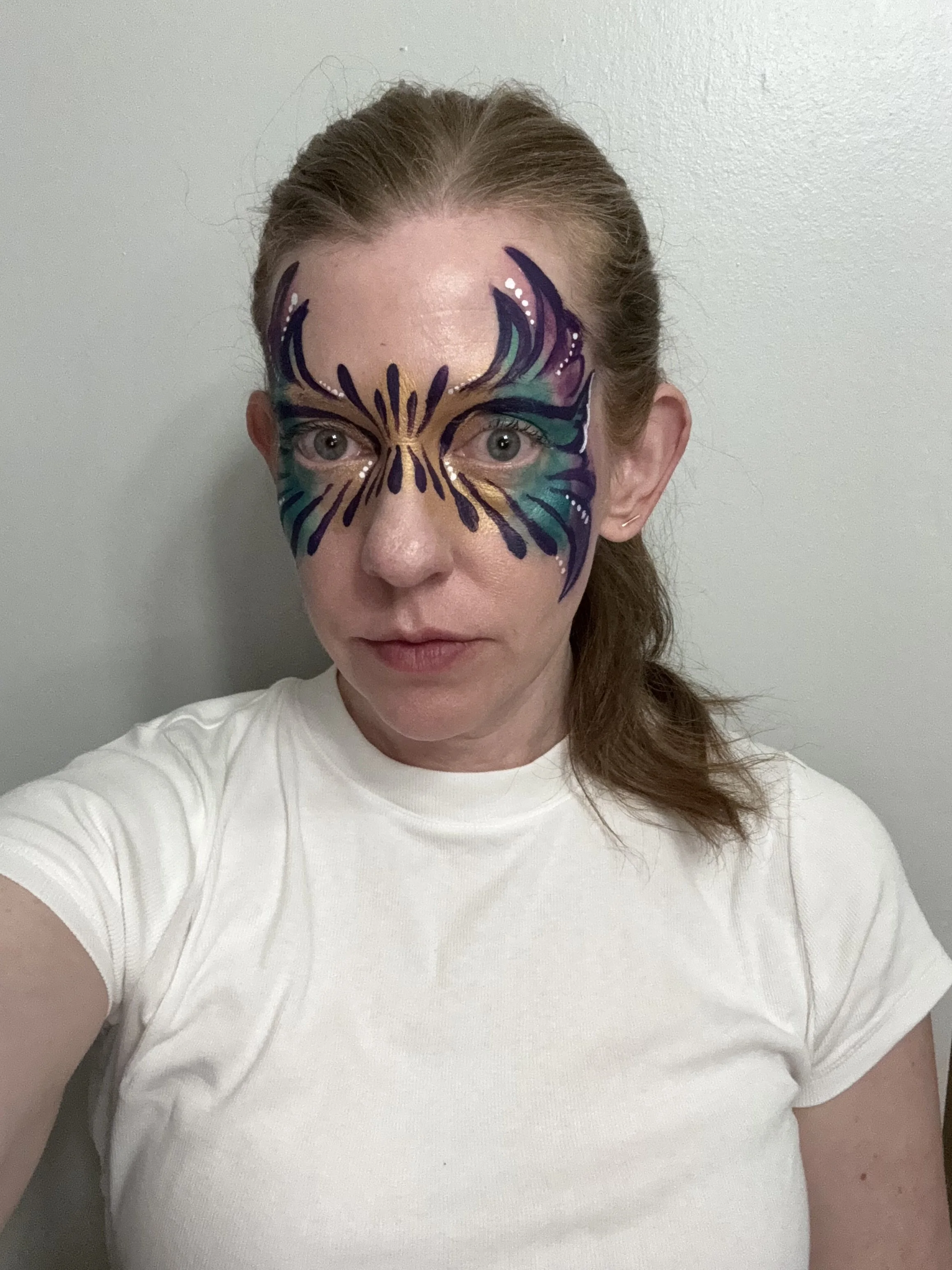 This demo face paint design shows a mardi gras mask look, an example of my constant paint practice!
