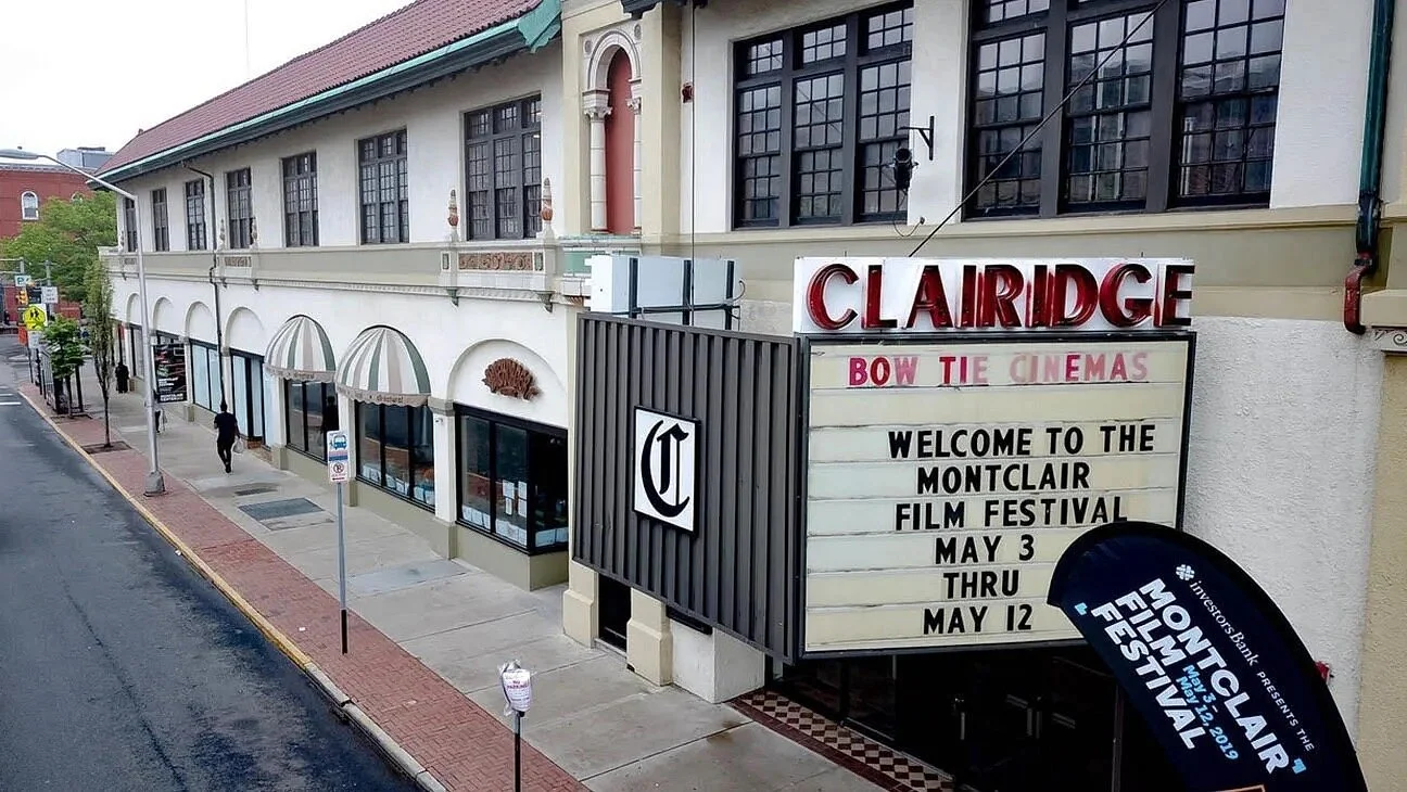Exterior view of Claridge Bow Tie Cinemas with a marquee sign welcoming to the Montclair Film Festival, with dates from May 3 to May 12.
