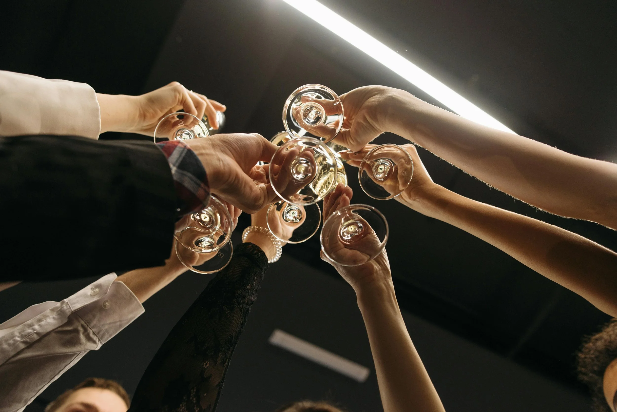 Friends or colleagues toasting with glasses of champagne at a celebration or gathering.