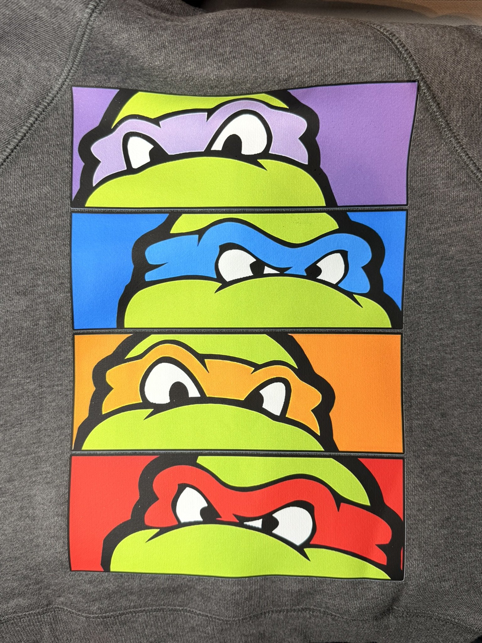 Four cartoon turtle faces with different angry expressions, each in a different color background: purple, blue, orange, and red.