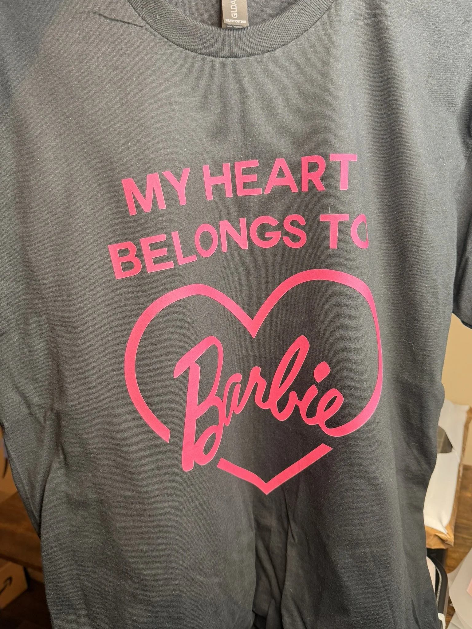 Gray t-shirt with pink text that reads "My heart belongs to Barbie" inside a pink heart outline.