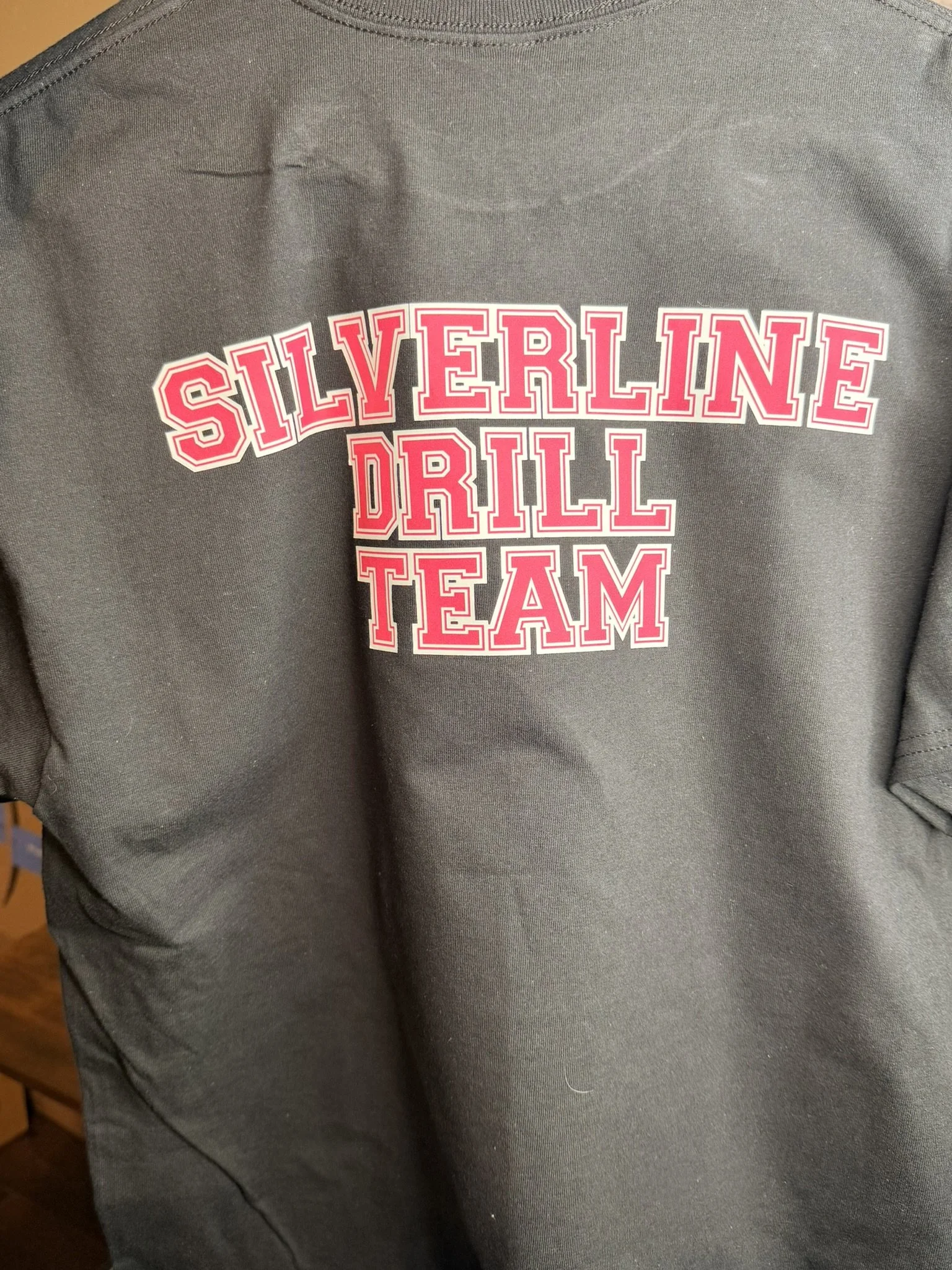 Gray sweatshirt with pink and white text that reads 'Silverline Drill Team'.