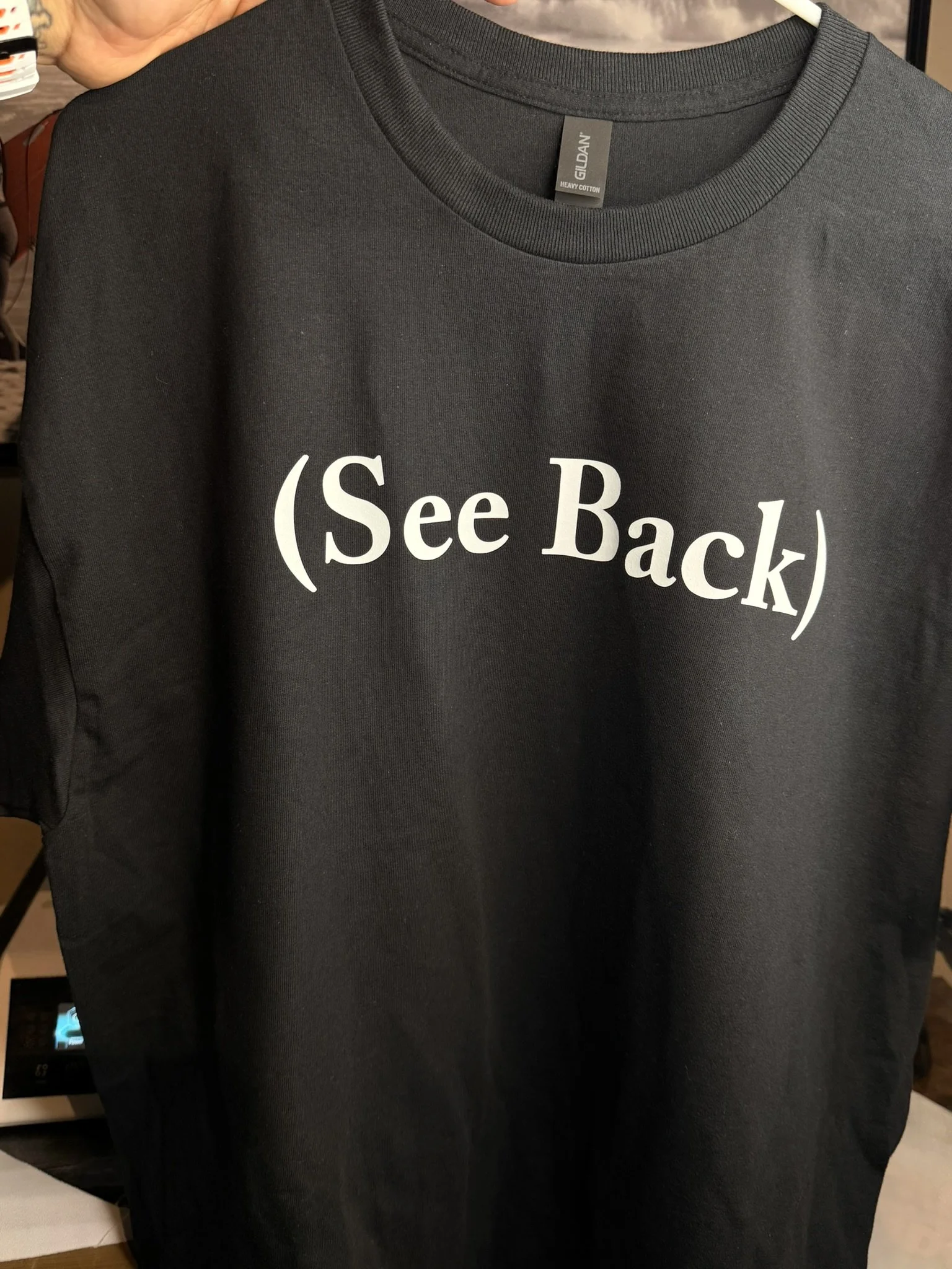 Black T-shirt with white text that reads '(See Back)'.
