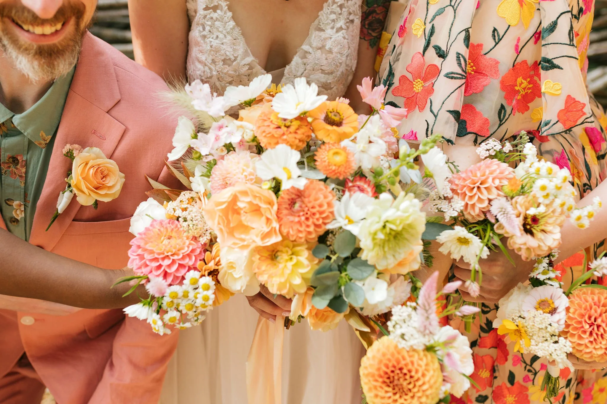 Close-up of a group of people holding bouquets of colorful flowers including roses, dahlias, and cosmos, during a wedding.

Photo by Char Marl Photography
Venue: The Aerie at Eagles Landing in Happy Valley, Oregon