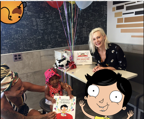 A woman sitting at a table with children celebrating a birthday with balloons, cake, and a question game for breakfast.