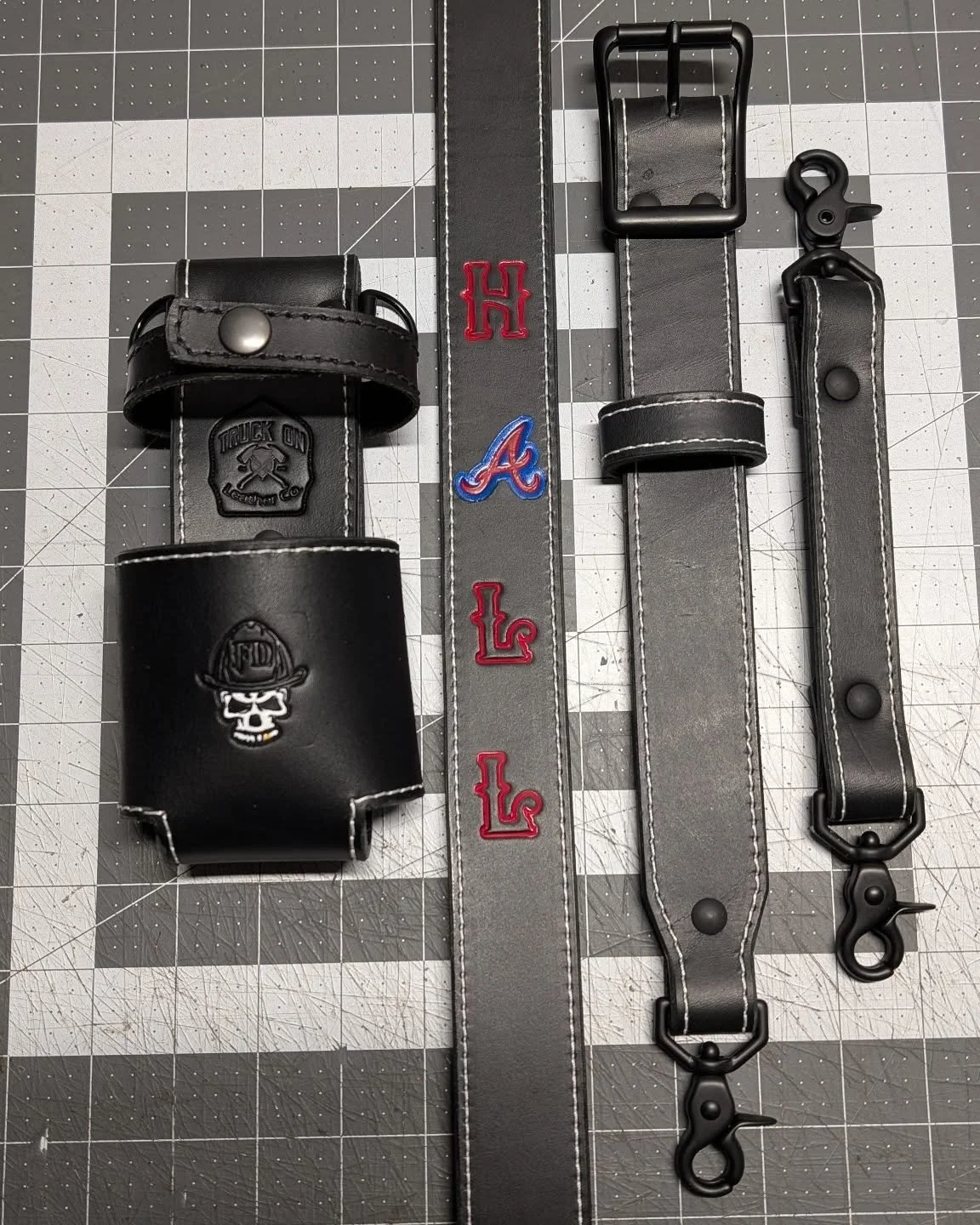 Sometimes the simple things stand out the most! This black and white strap with pops of red is off the bench and ready for work. 

----Project Info----

Leather color: Black

Stitching:&nbsp;White

Hardware:&nbsp;Black

Stamps: Braves &quot;A&quot;, 