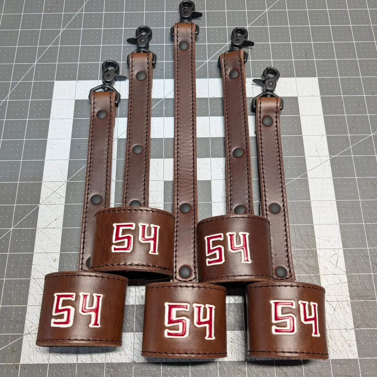 A batch of Flashlight Holders headed out to the Springs! 

This station requested a lanyard attachment to allow the light to drop down low to help search! Very cool idea! 

----Project Info----
Leather color: Hickory Brown
Stitching: Black
Hardware: 