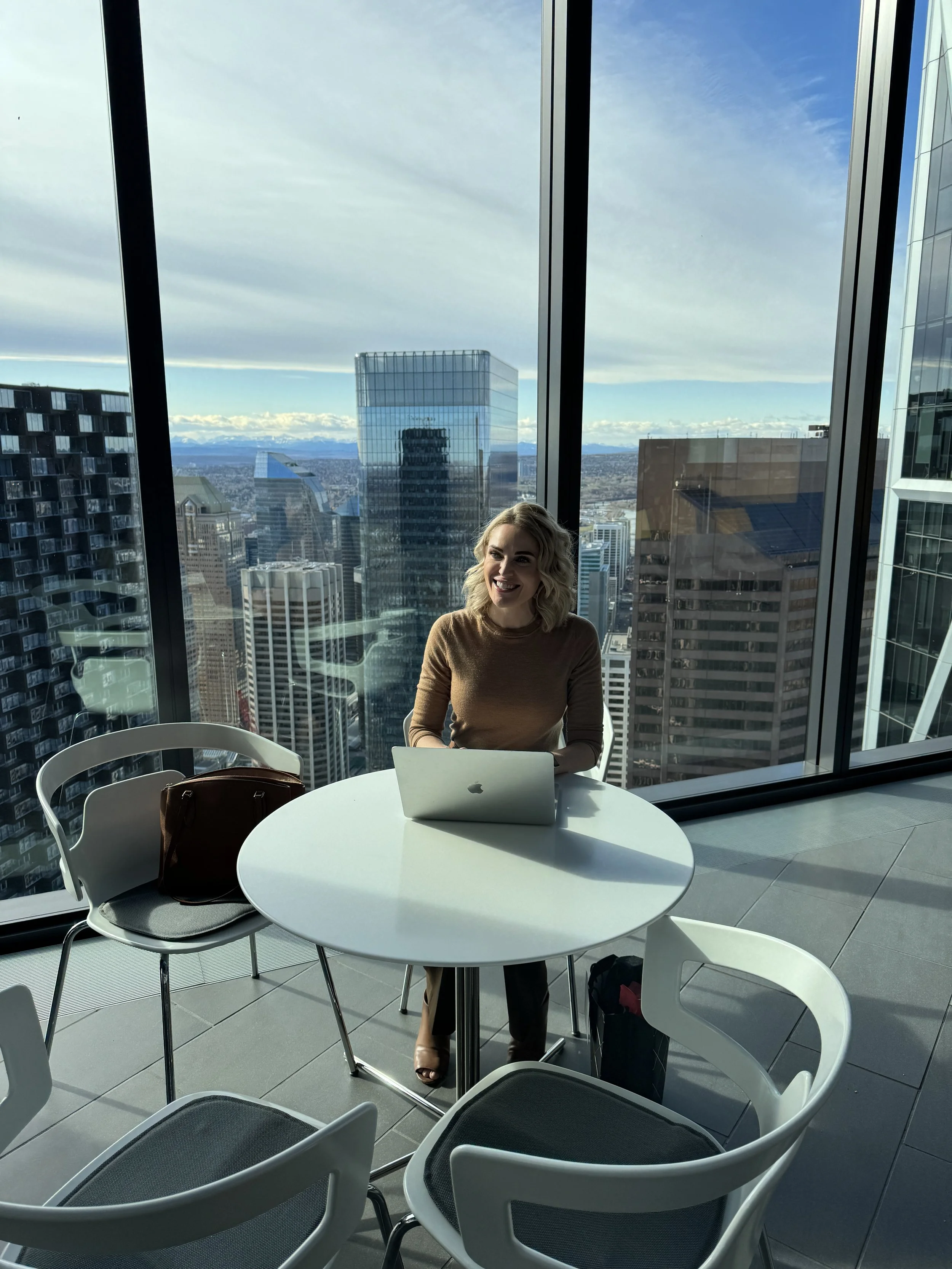 Rebecca Bultsma working at a laptop in a bright office.