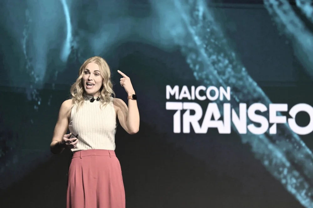 Rebecca Bultsma explaining AI on stage at MAICON.