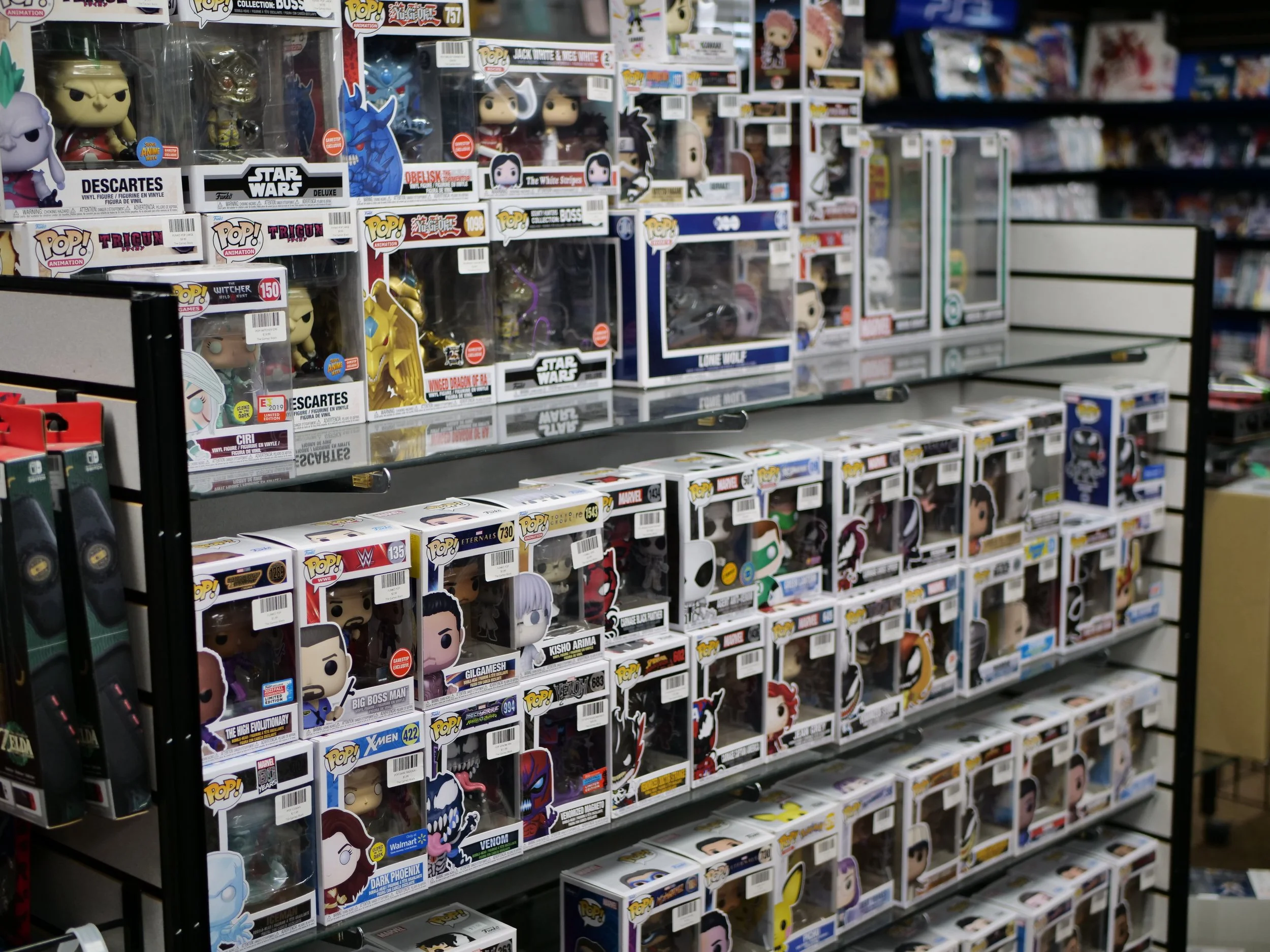 Display of various Funko Pop! figures on store shelves, including characters from Marvel, Star Wars, WWE, and other franchises.