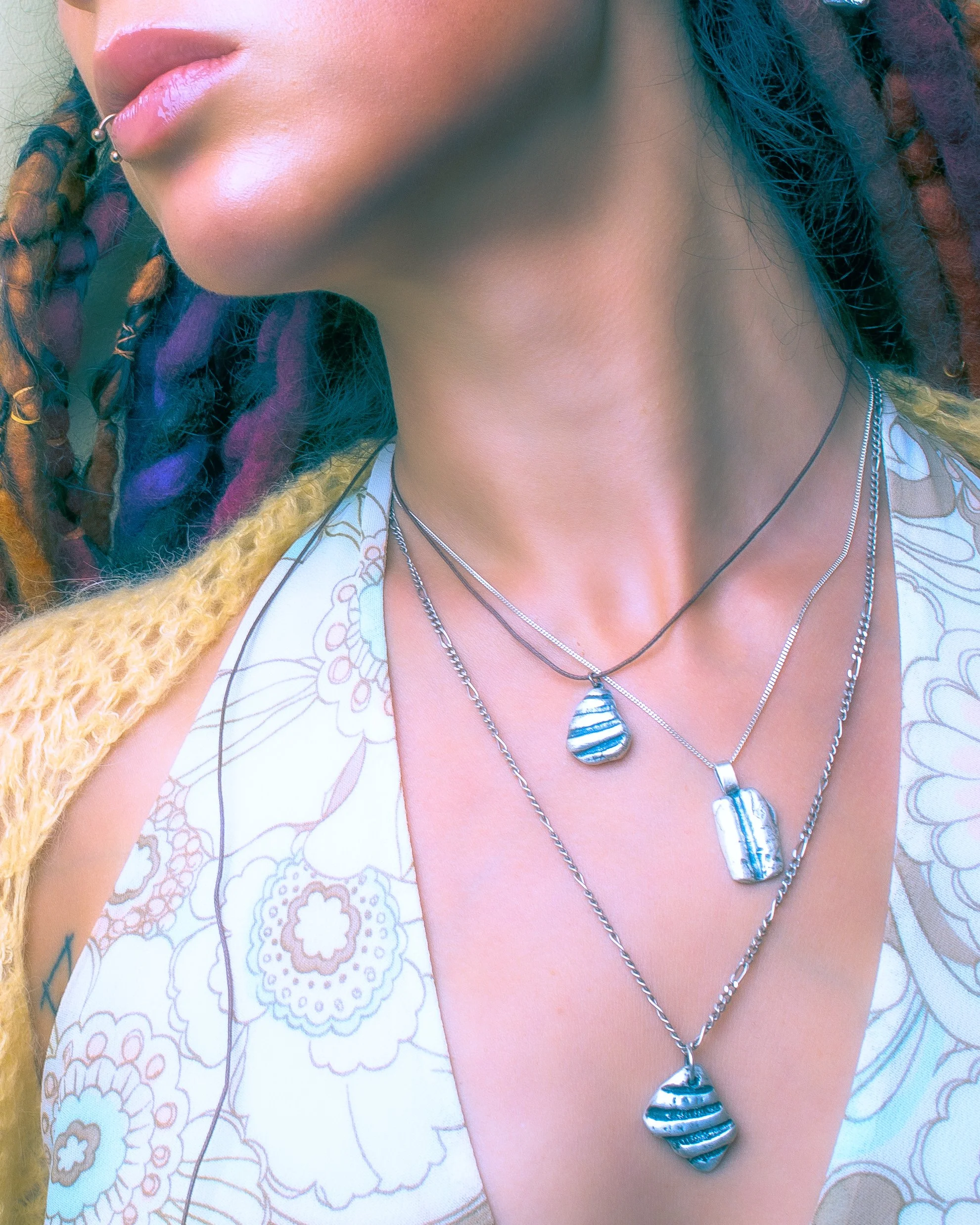 Luxury sterling silver sea shell talisman necklace charm made from real sea shells, handcrafted artisan jewelry from the Netherlands.