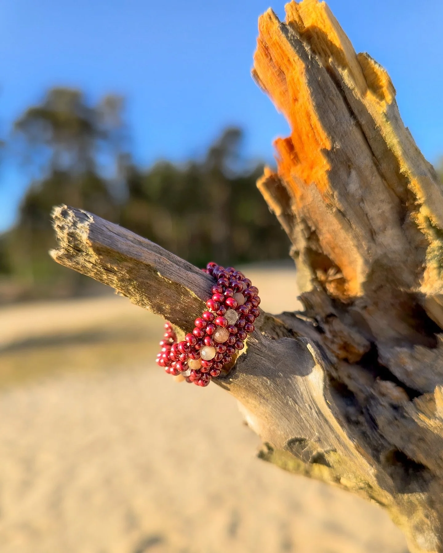 A small circle of deep red and moonstone &mdash;
woven with warmth, softness, and a little lunar magic.