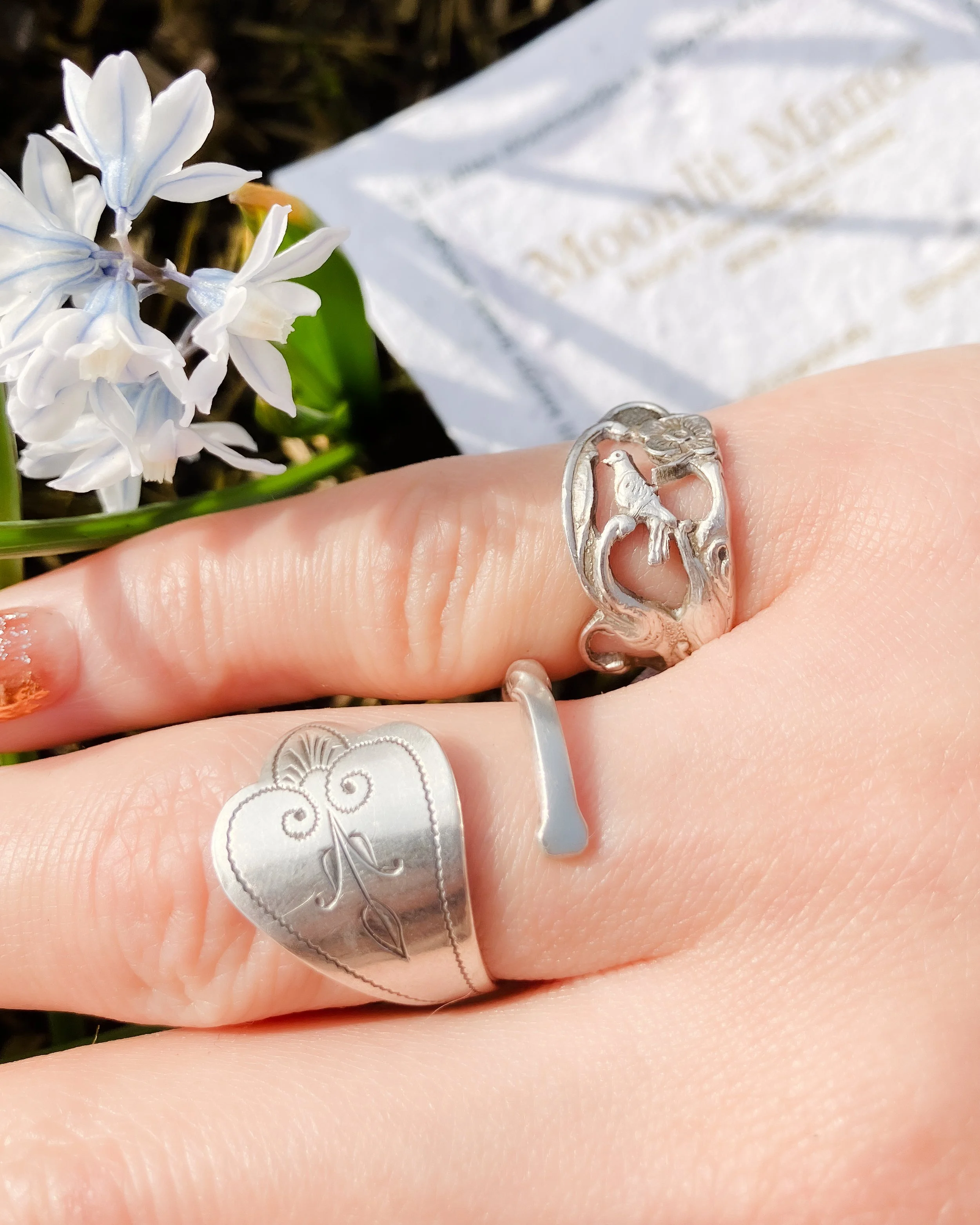 Vintage Dutch 925 sterling silver rings made from fork handles with openwork songbird and floral motif, handmade by Moonlit Manor Netherlands, on human hand with white flower