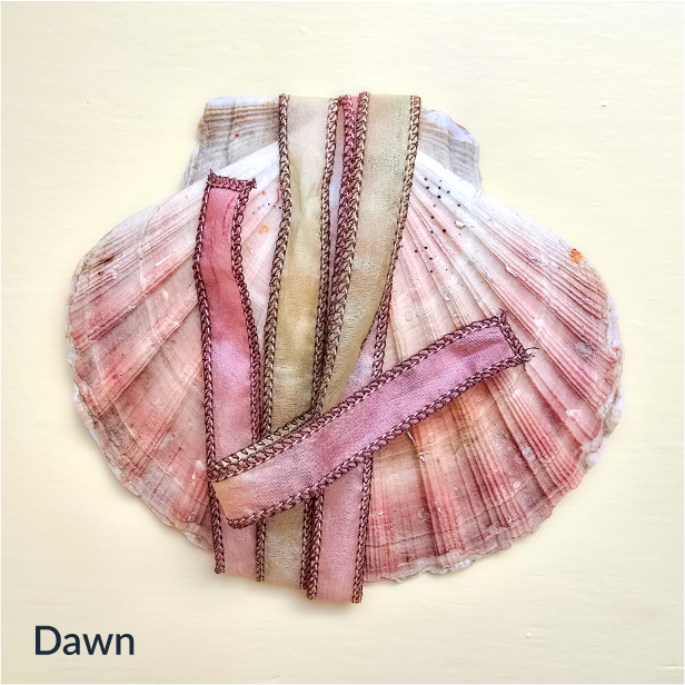 Upcycled Indian sari silk ribbon in rose, pink and champagne, draped on a pink scallop shell