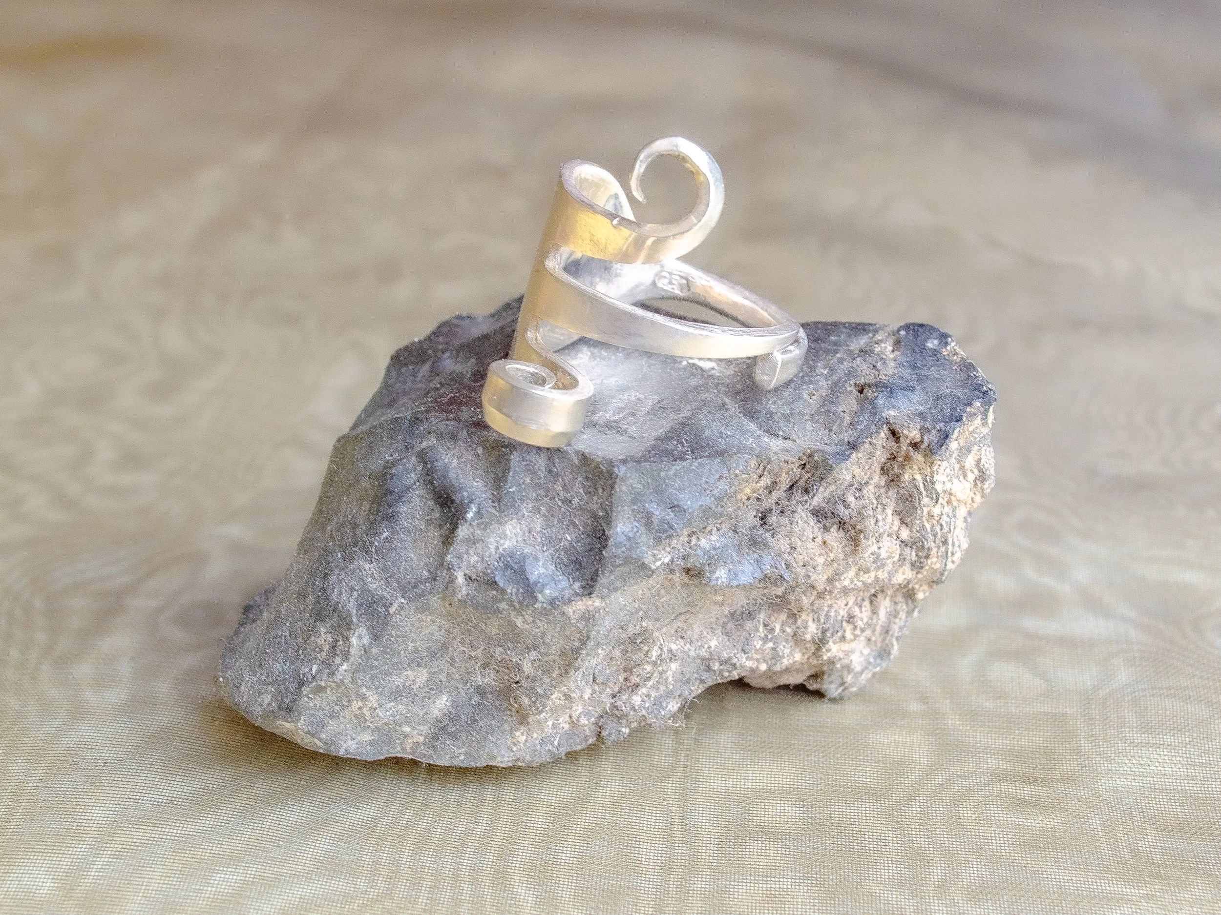 Wide vintage Dutch 925 silver ring made from fork handle with bent tines forming sculptural spirals, handmade by Moonlit Manor Netherlands, on grey stone