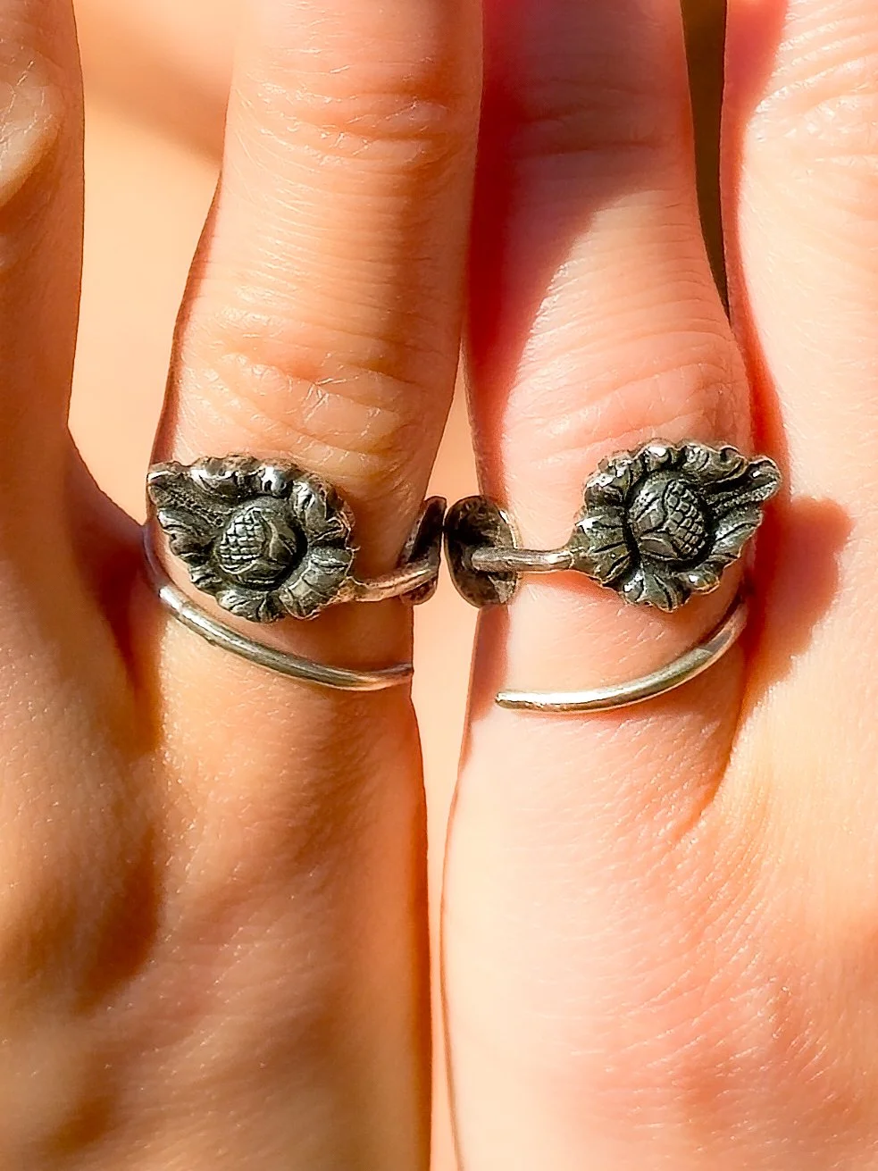 Vintage German 800 silver rings handmade in the Netherlands from cocktail picks, ornate Jugendstil flower motif, on human hand