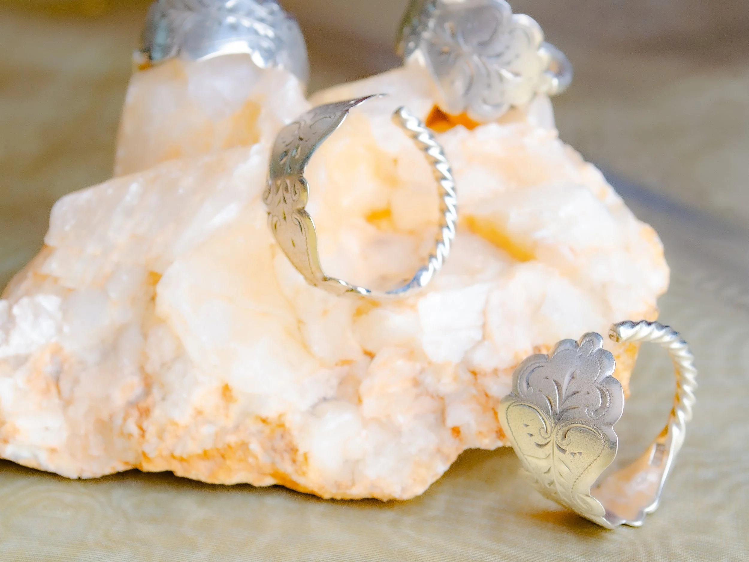 Vintage Dutch 925 sterling silver spoon rings with baroque engraving and rope edge, handmade by Moonlit Manor Netherlands, on white mineral crystal