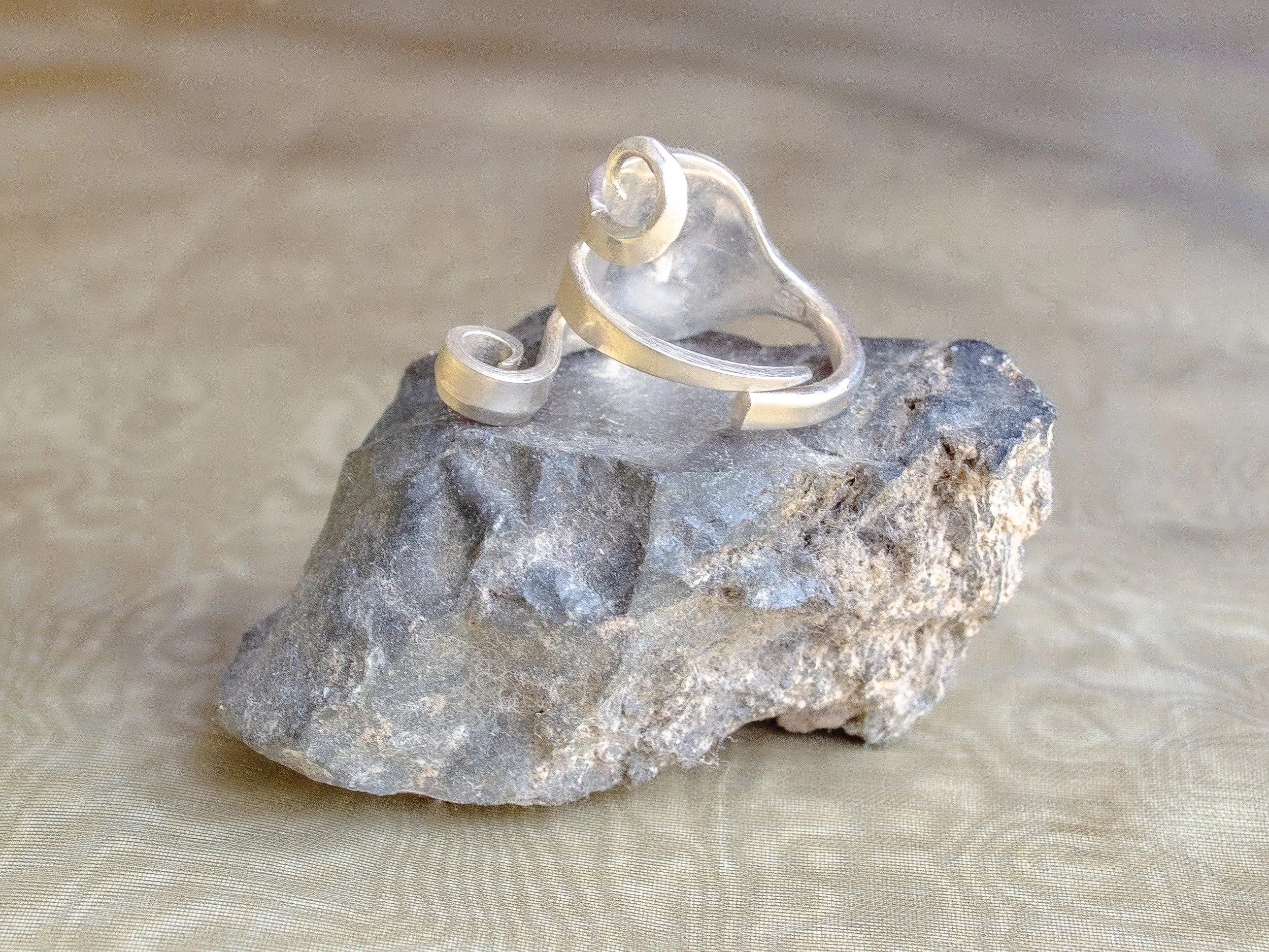 Wide vintage Dutch 925 silver ring made from fork handle with bent tines forming sculptural spirals, handmade by Moonlit Manor Netherlands, on grey stone