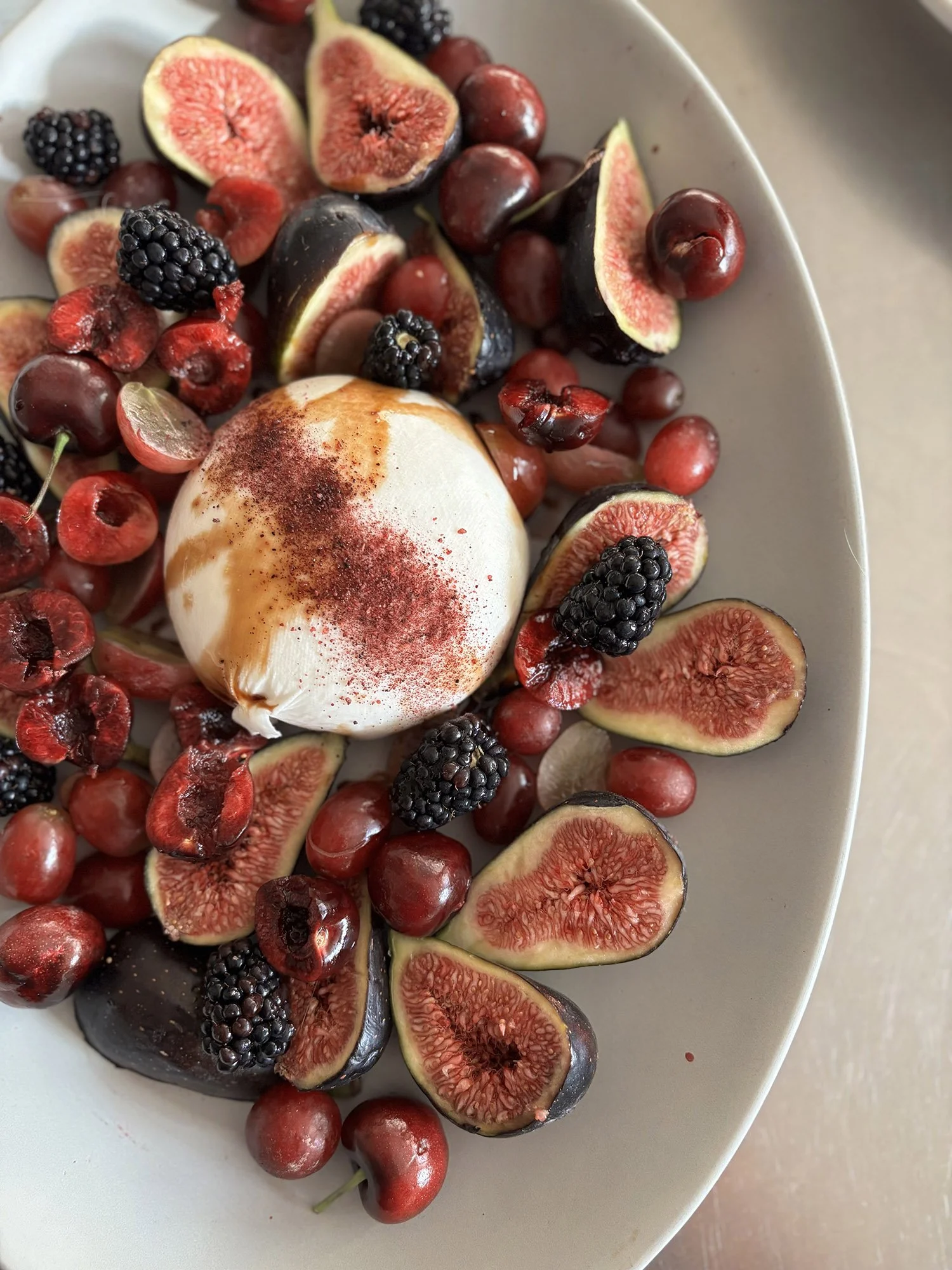 BURRATA WITH SUMAC, POMEGRANATE GLAZE, AND RED FRUIT