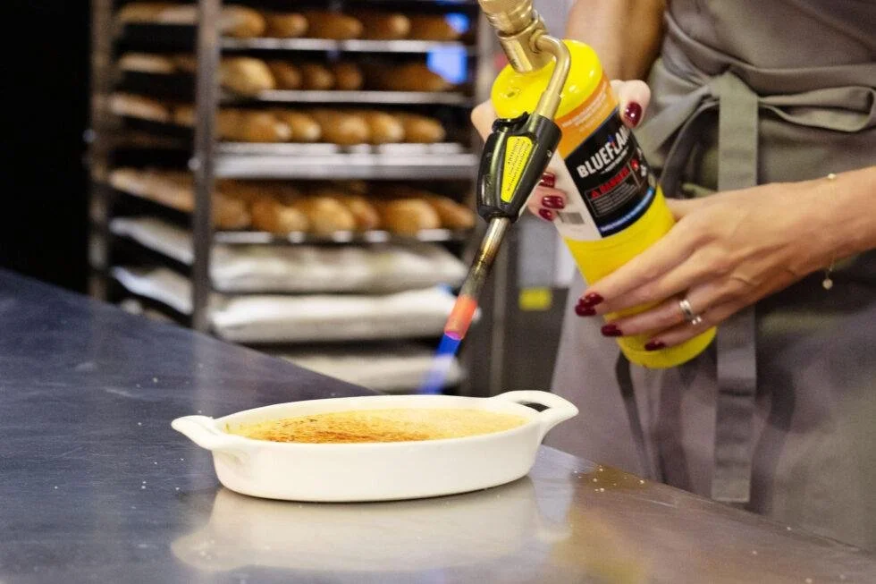 Lidija with blow torch carmelizing creme brulee