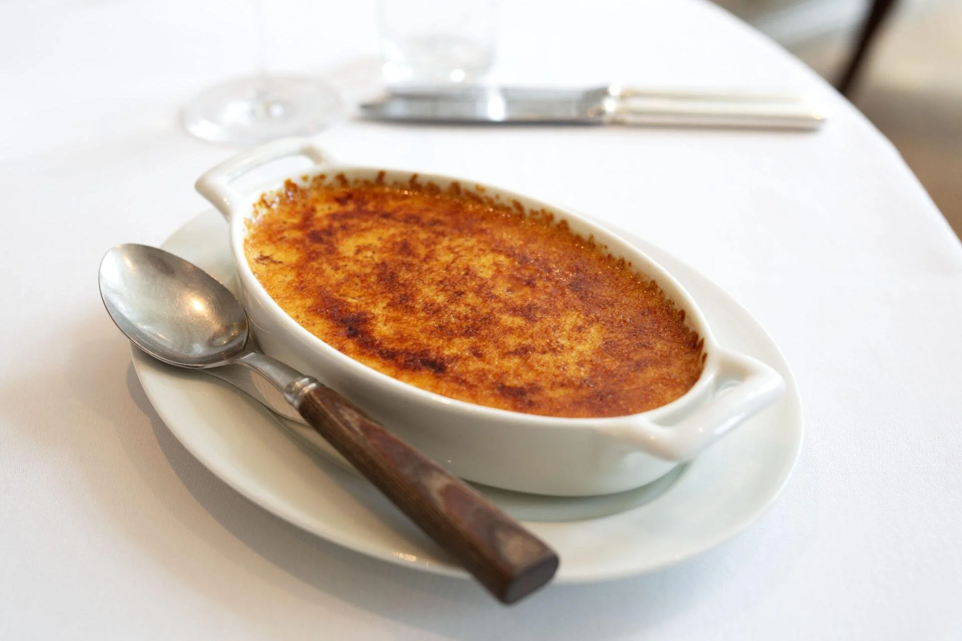 creme brulee dessert plated at la petite maison