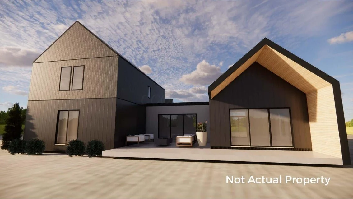 Rendering of a modern two-story house with a black metal roof, black vertical siding, and large windows. There is a covered porch on the left side with outdoor seating and landscaping with tall trees and shrubs in the front yard. Clear sky with scattered clouds in the background.