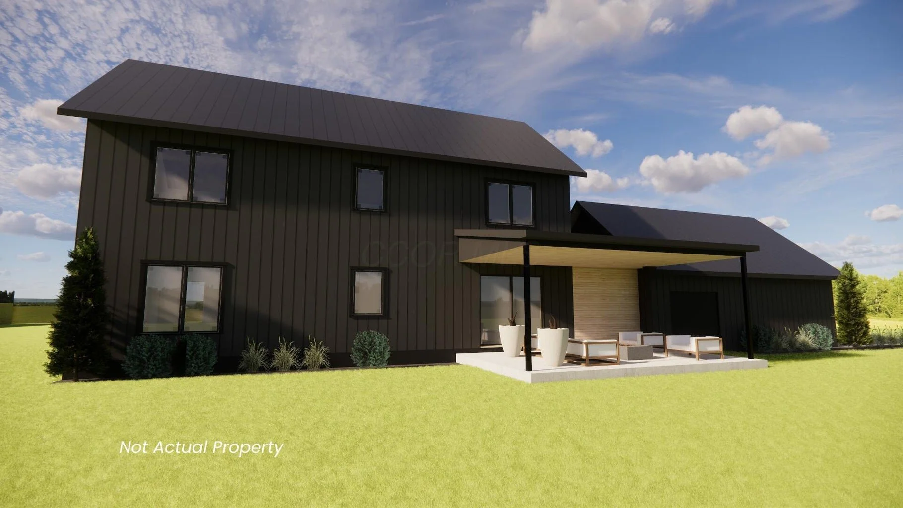 Modern two-story black house with patio, outdoor furniture, and green lawn, under a partly cloudy sky.