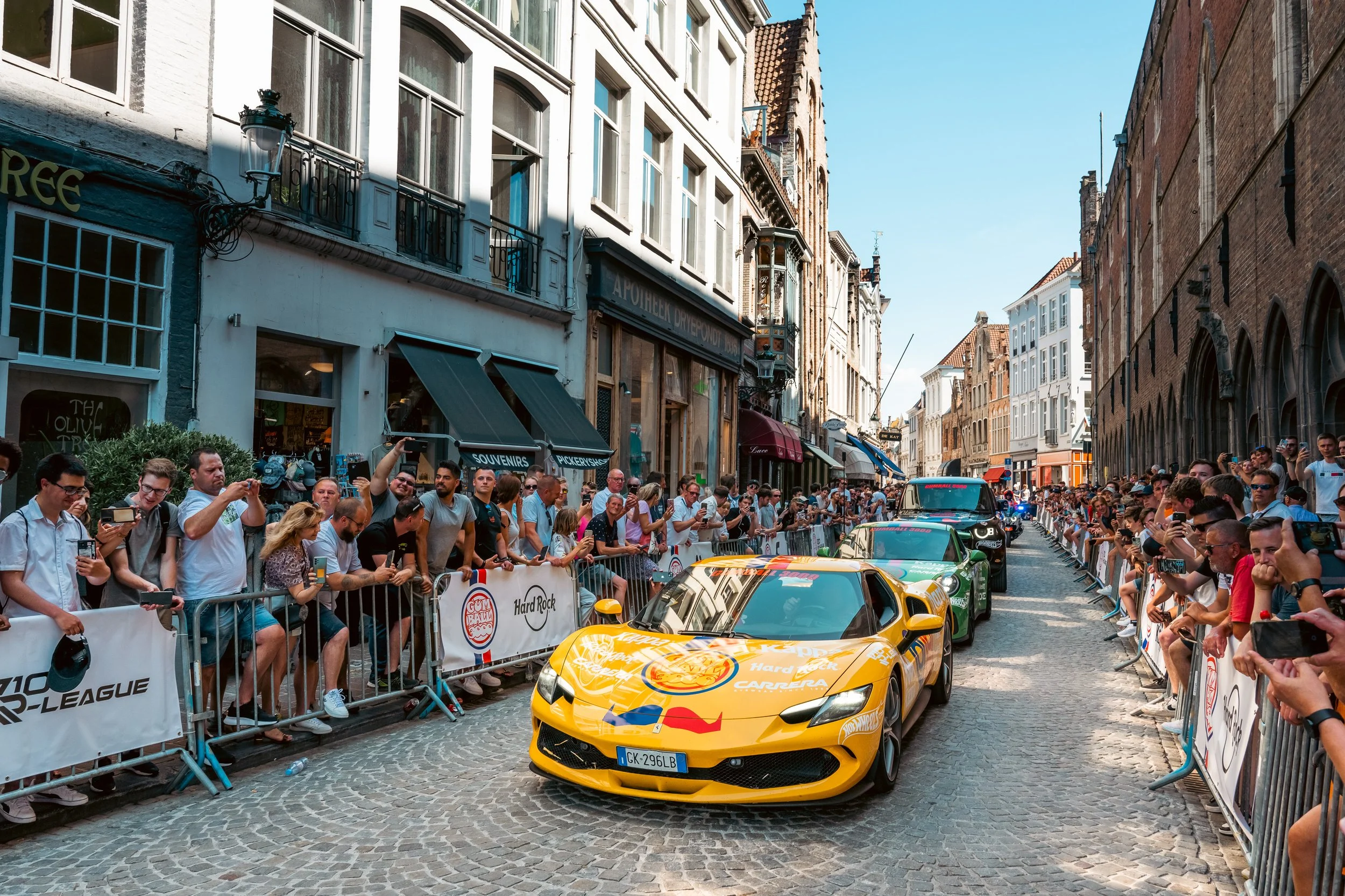 Police Escorts bring Gumball cars into Market Square, Bruges