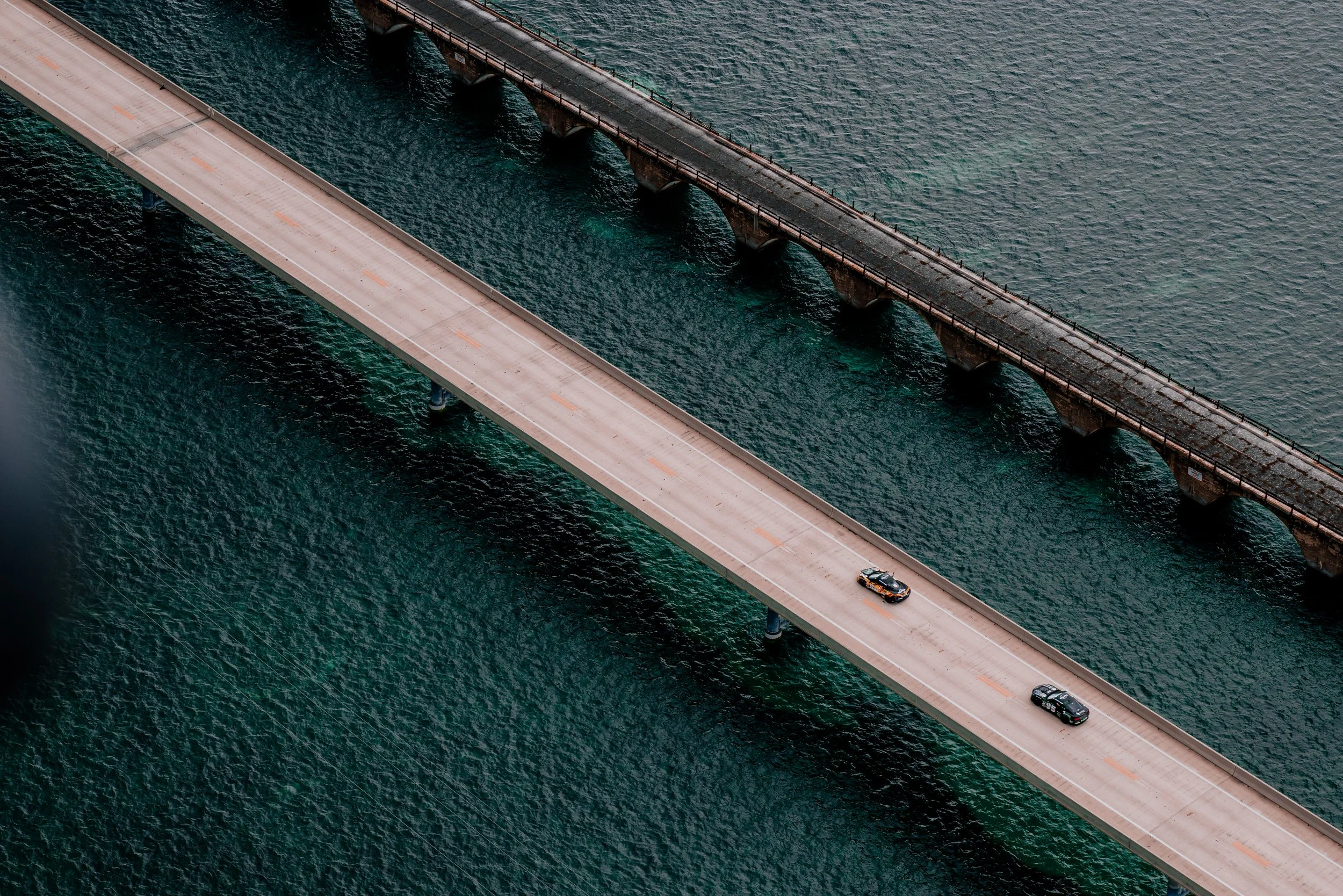 Gumball cars heading to Key West along the famous Seven Mile Bridge