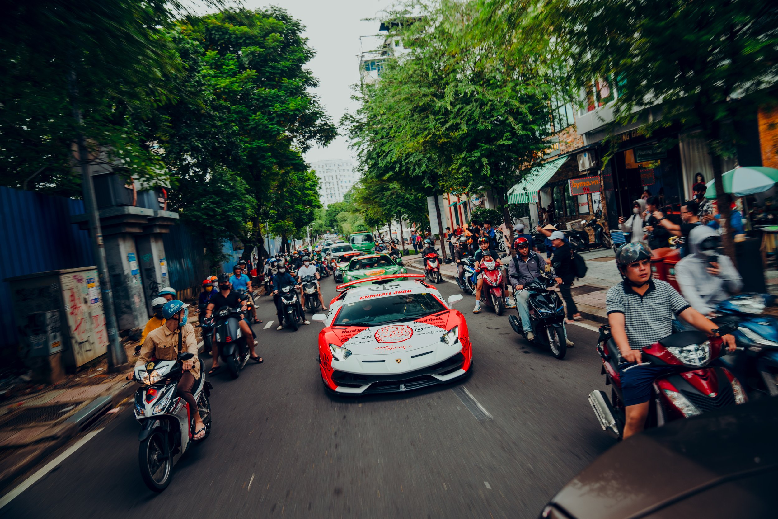Gumball cars arriving into Ho Chi Minh City under police escorts