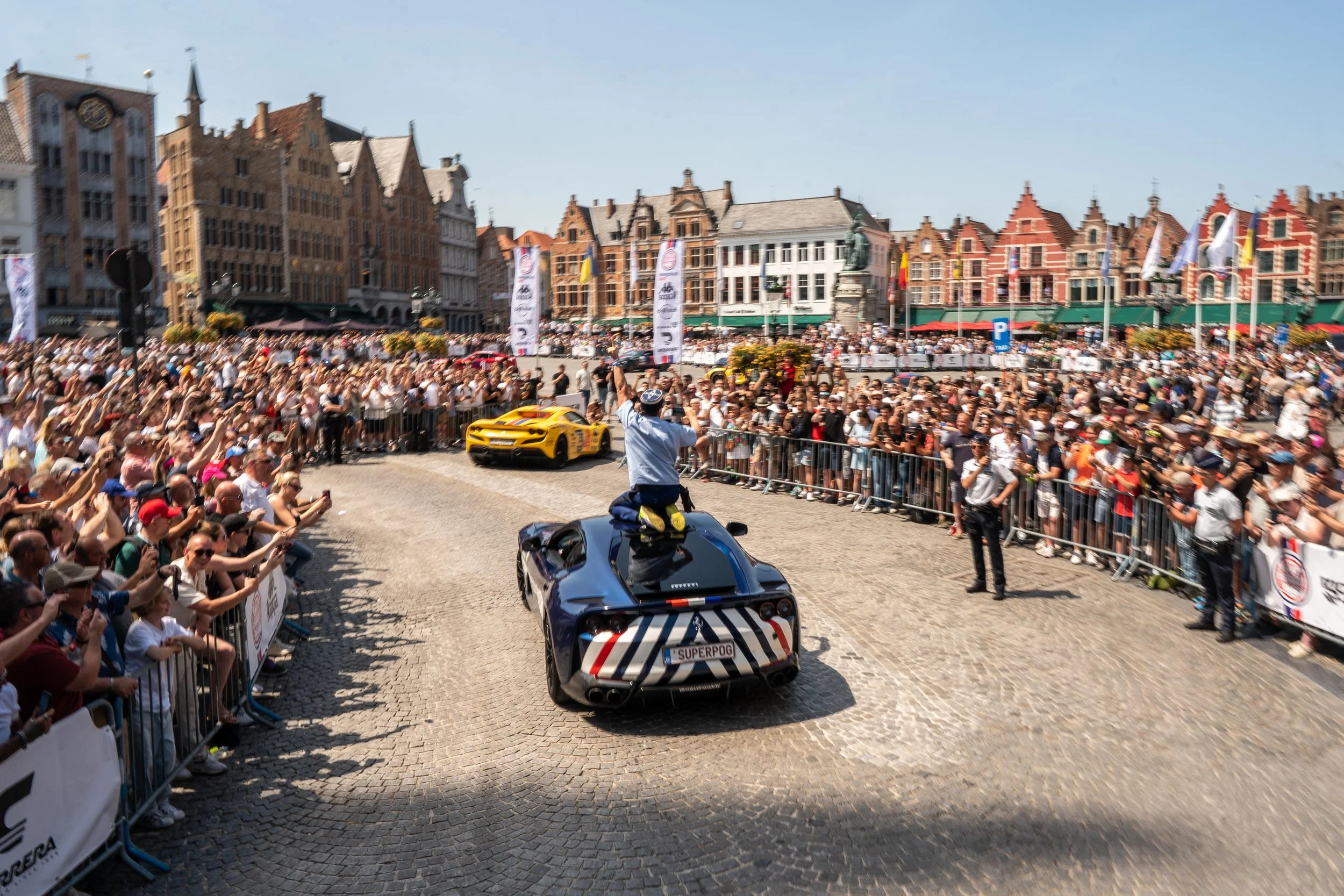 Thousands of fans welcome Gumball cars into Market Square, Bruges