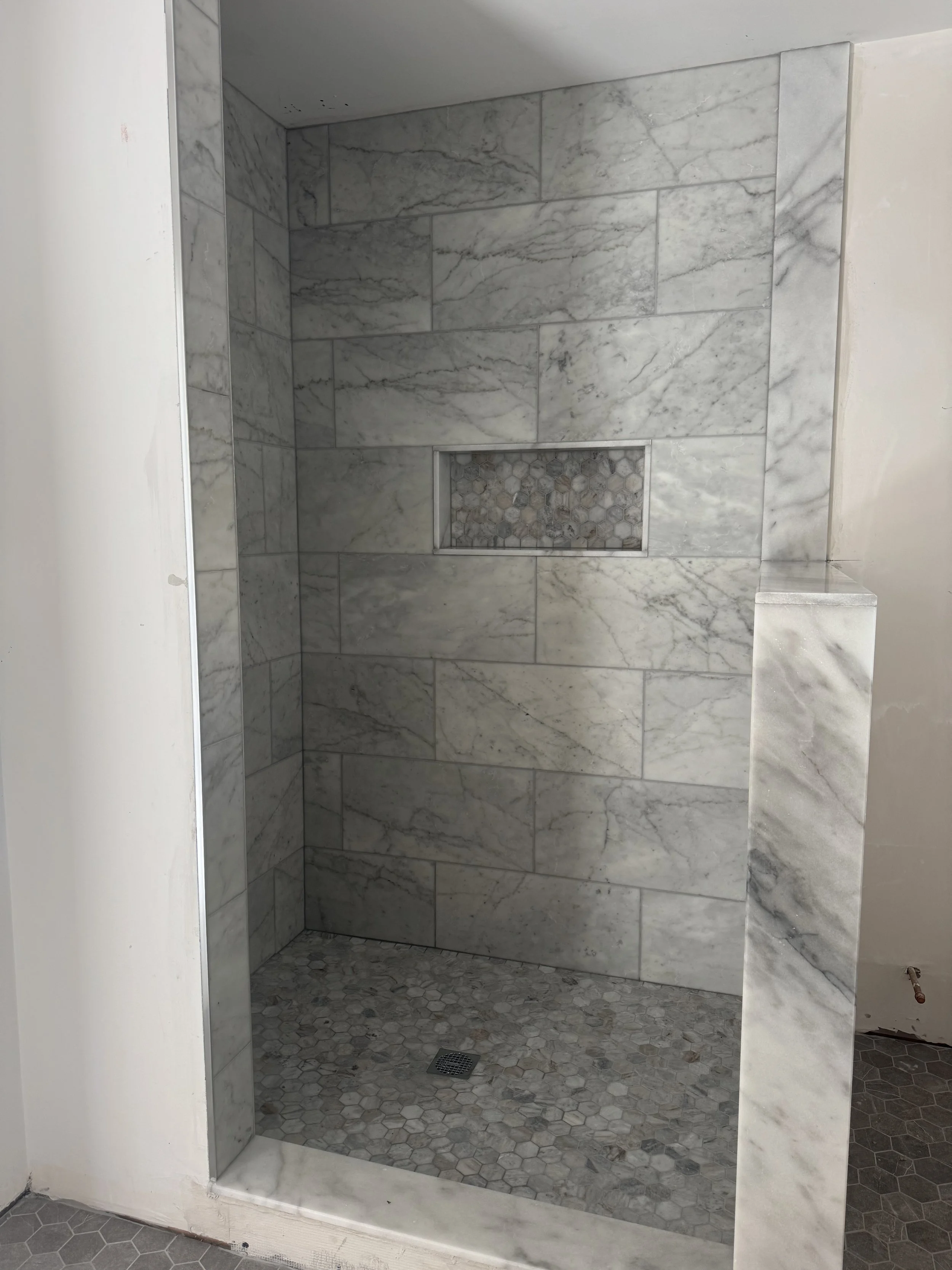 Luxury bathroom tile installation specializing in custom shower walls, designer layouts, and elegant finishes for refined spaces.