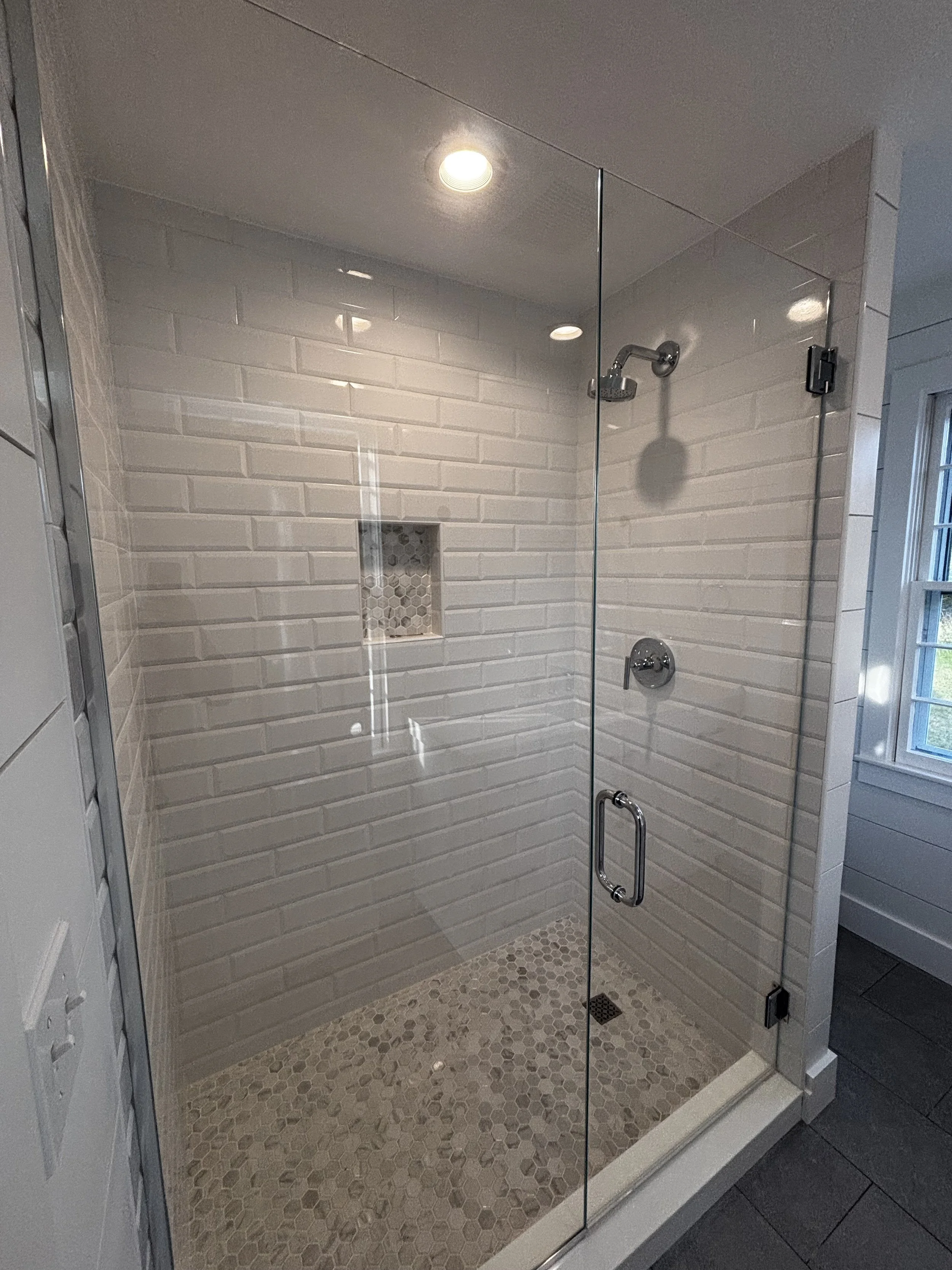 Luxury bathroom tile installation using premium materials and custom designs for elegant showers, floors, and modern bathrooms.