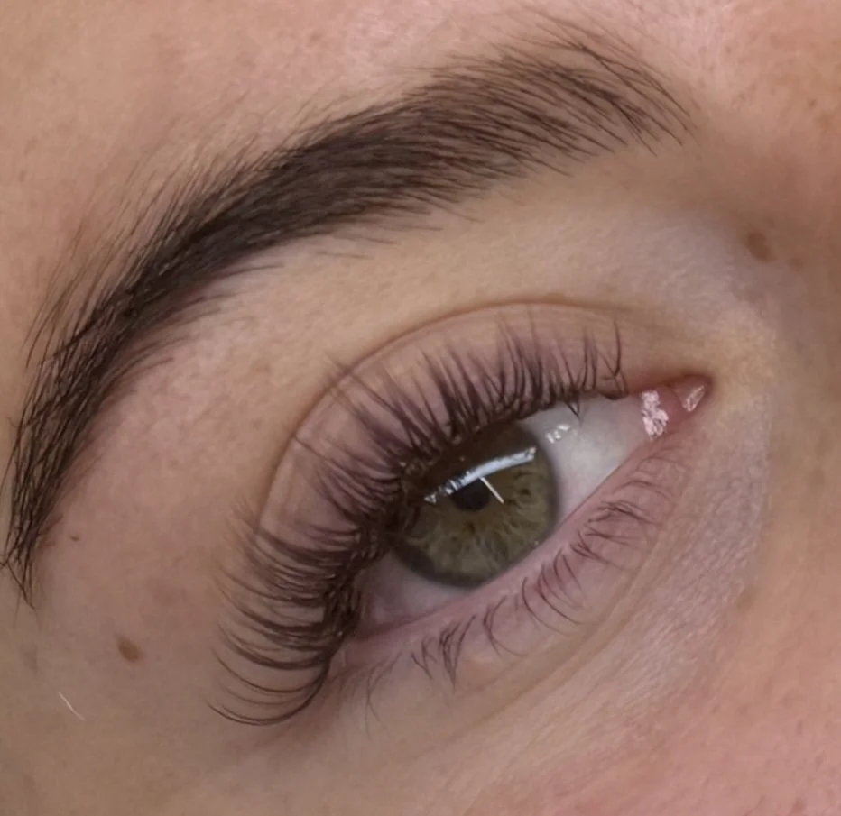 Close-up of a green eye with natural makeup and long lashes