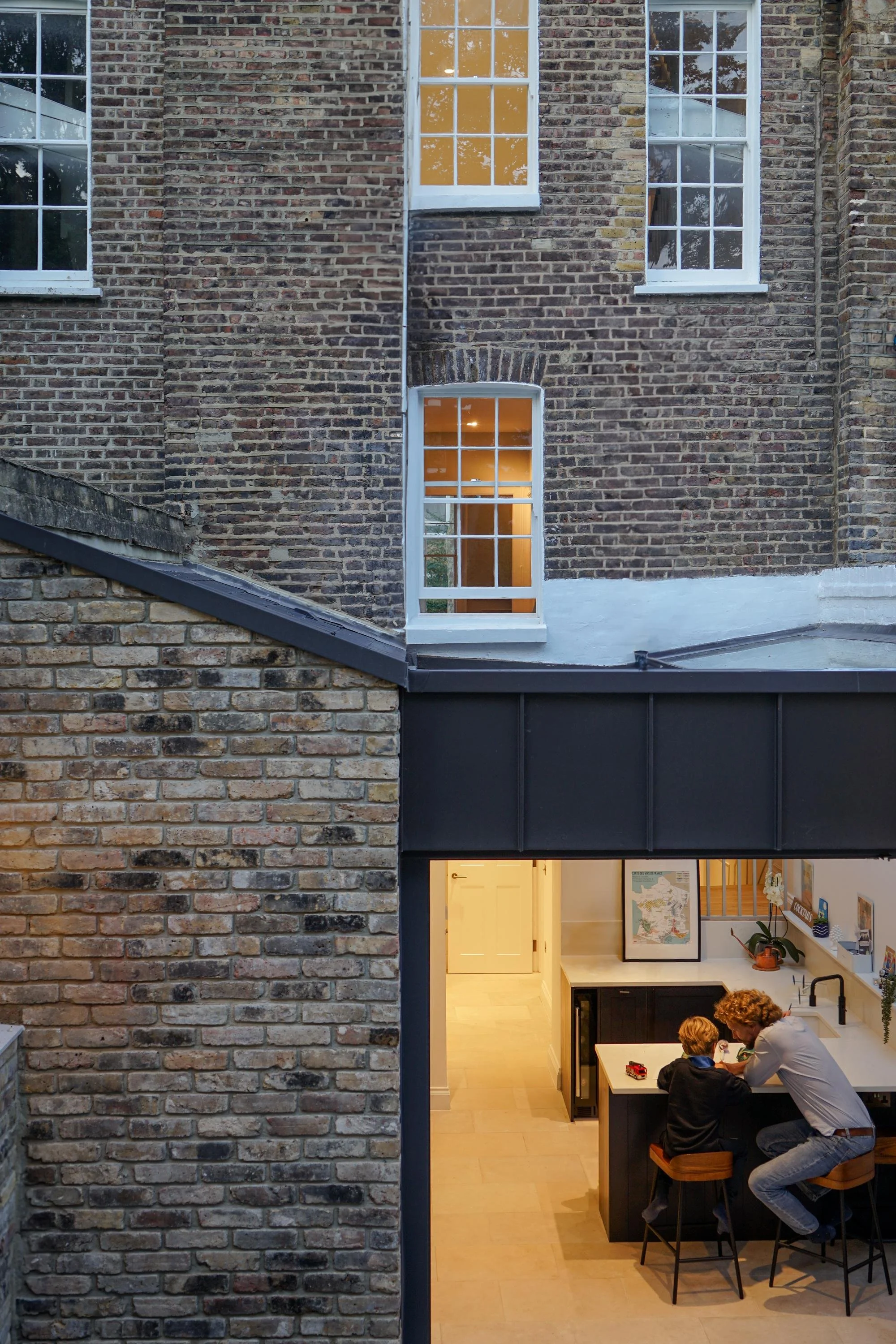 A geometric abstract logo featuring a circular pattern of segmented, light green rectangles on a black background.