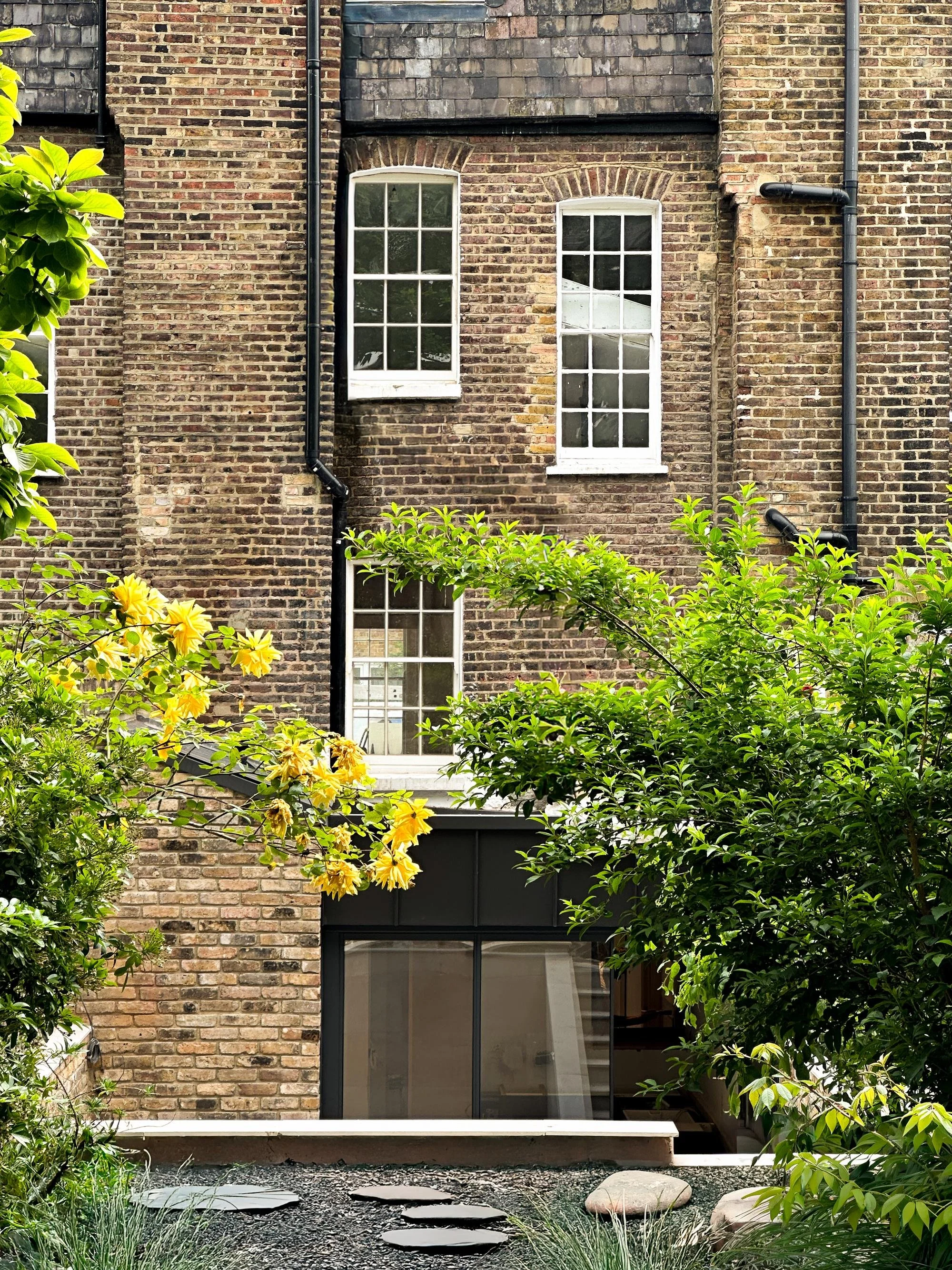 A black background with a white, geometric, circular pattern formed by interconnected rectangular shapes.