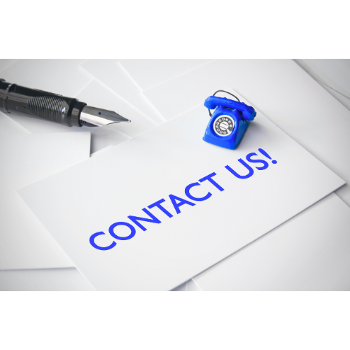 A white envelope with blue text saying 'CONTACT US!', a black fountain pen, and a small blue rotary dial telephone on a white surface.