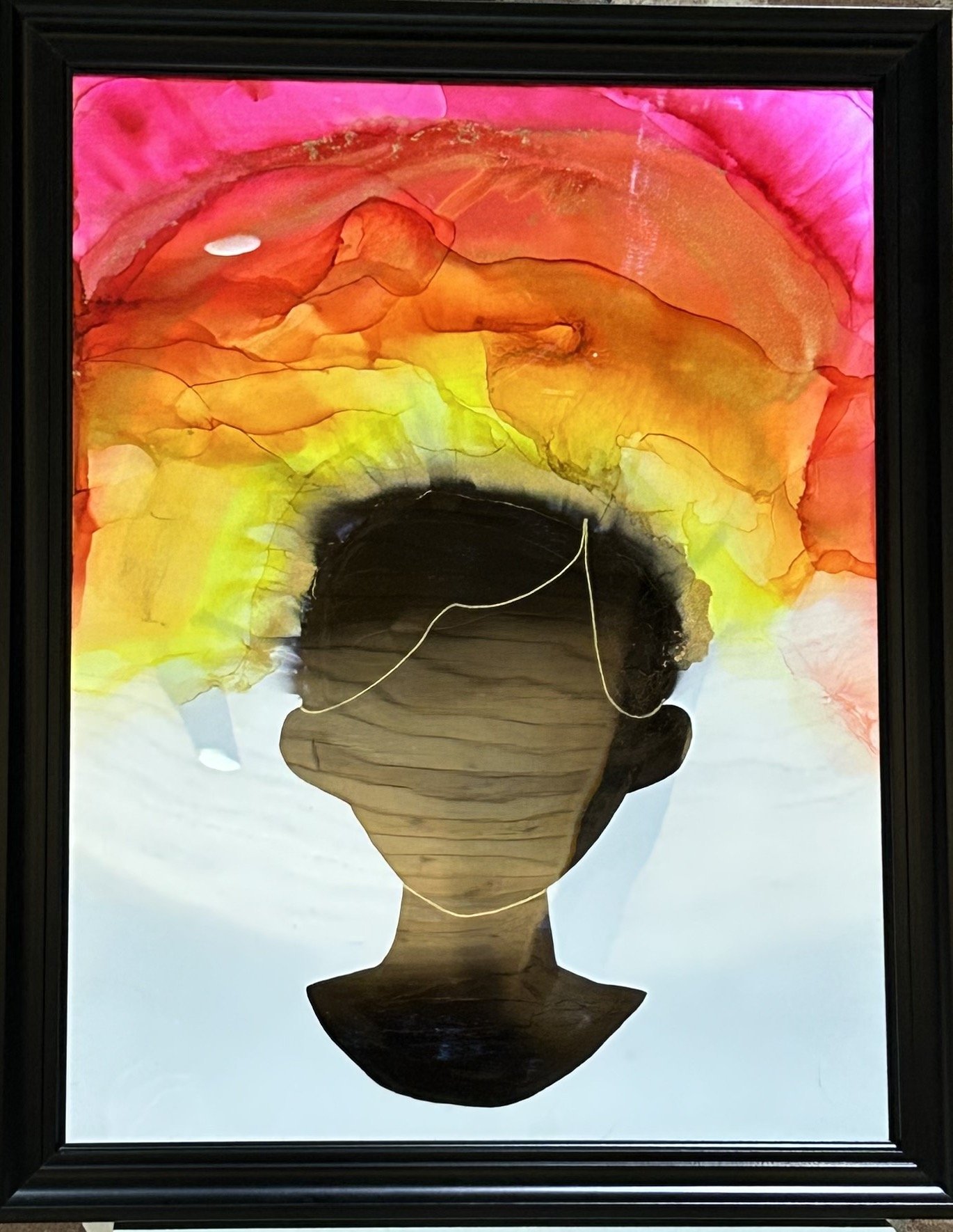 A framed watercolor painting of a person with short hair, depicted in silhouette. The person's head is filled with colorful abstract waves in shades of pink, orange, red, yellow, and green, resembling a vibrant thought cloud.