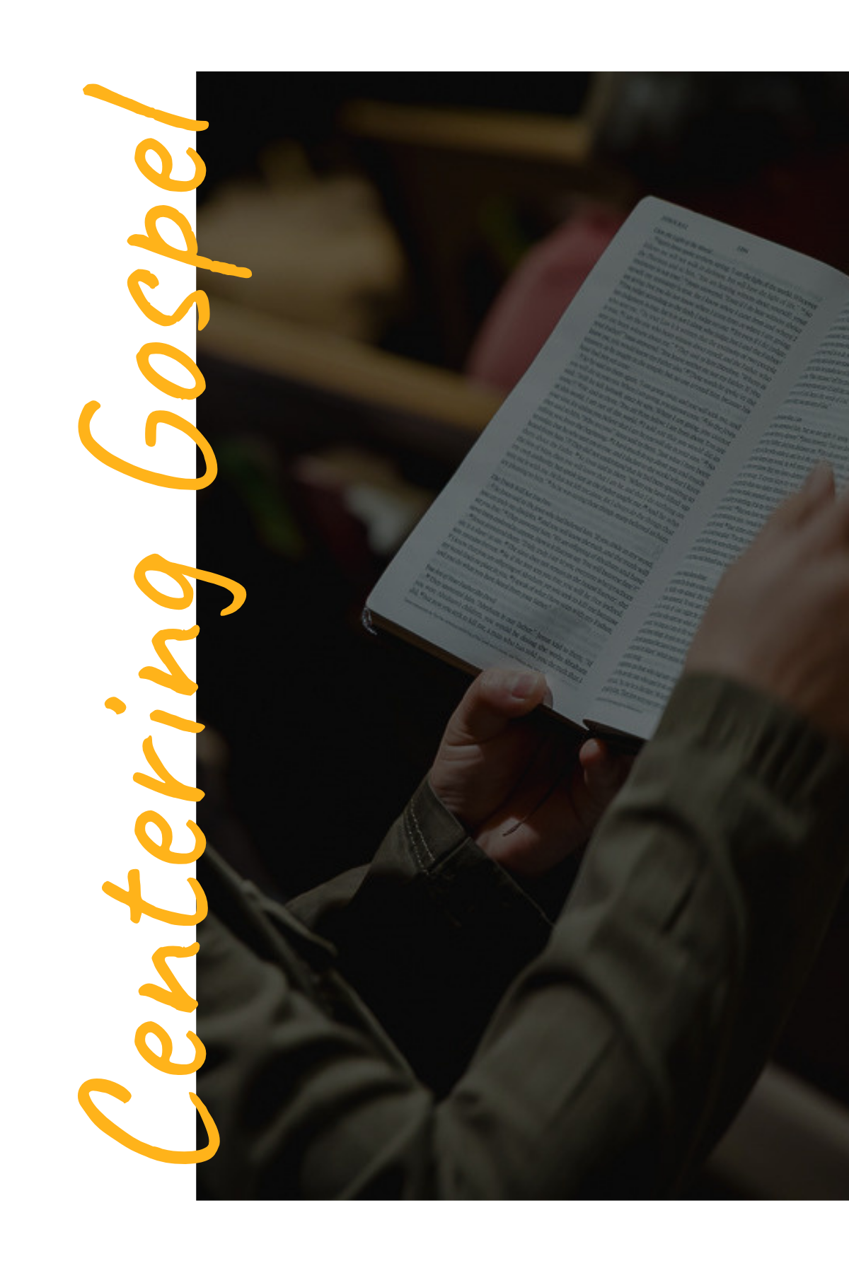 A person wearing a beige jacket holding an open book with small text printed on the pages. The person's hand and part of their sleeve are visible. There are other books and objects blurred in the background.
