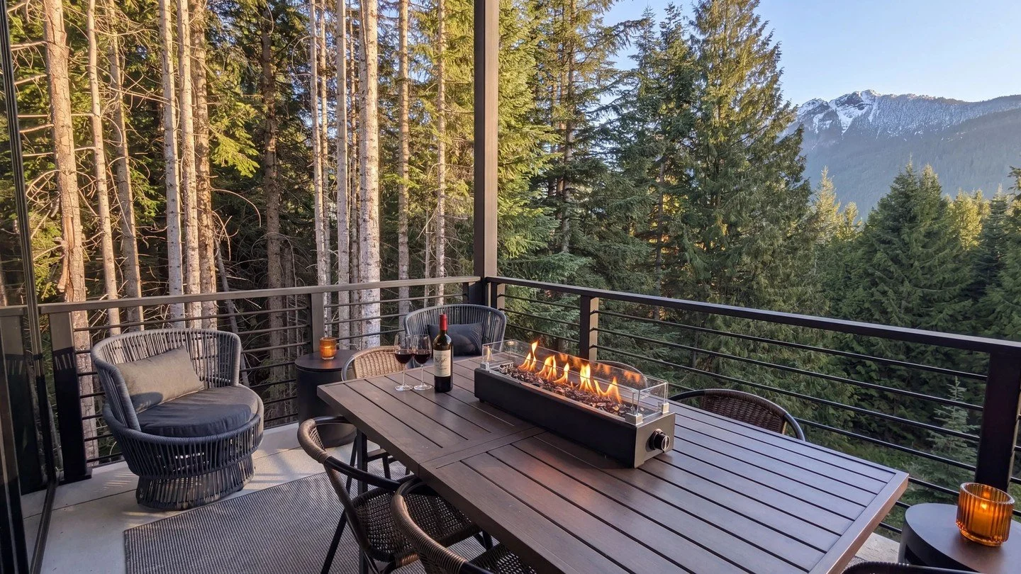 Soak in panoramic peaks from our covered deck at Hyak. Pour a glass of wine and watch the sunset glow over the old-growth forest. Cozy up by the fire table and reward yourself after a day of adventure in the Cascades. Book your getaway today! #Snoqua