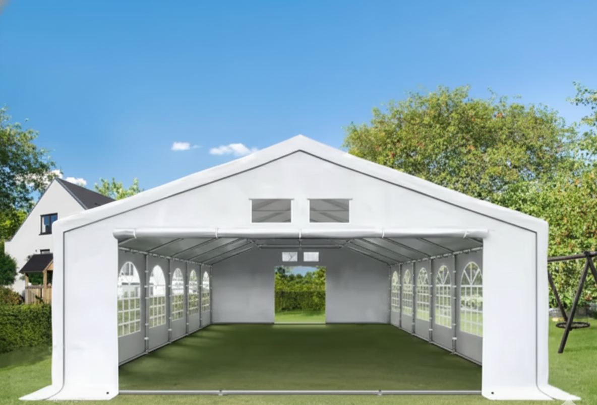 Carpa blanca en un jardín con árboles y casas al fondo, cielo azul y nubes.