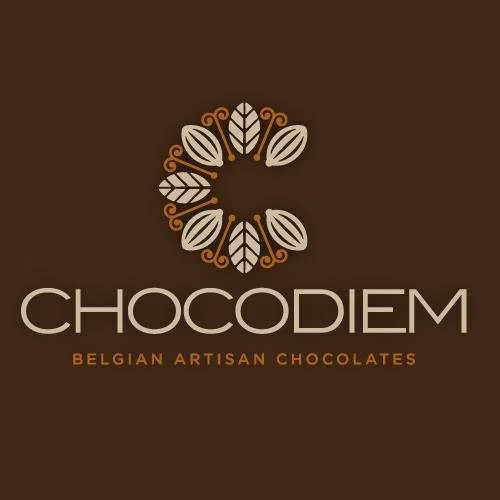 Logo for Chocodiem Belgian Artisan Chocolates featuring a circular design with stylized cocoa leaves and curls on a brown background.