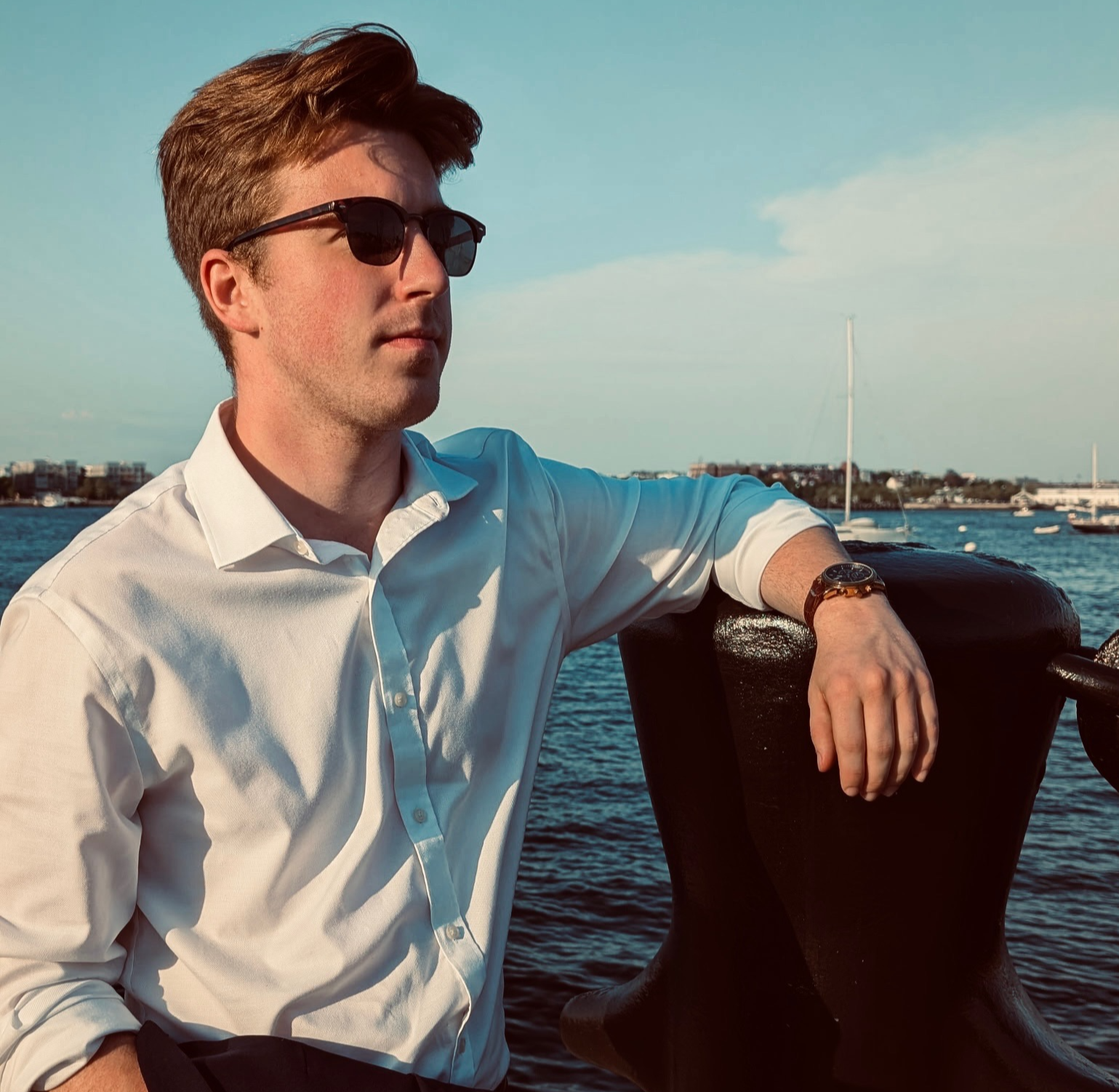 Connor Murray by the shore looking off into the distance.