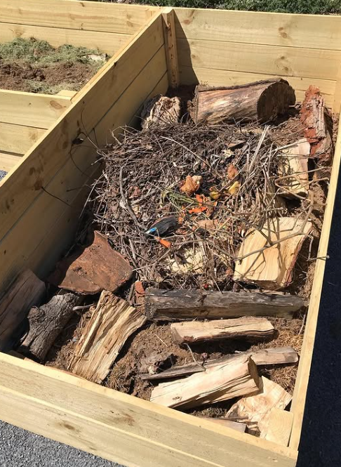 Filling raised beds can be expensive, especially if they're very deep, unless you use a method called Hugelkultur. This method layers materials from around your yard that will break down, providing beneficial mycelium and other nutrients that will fe