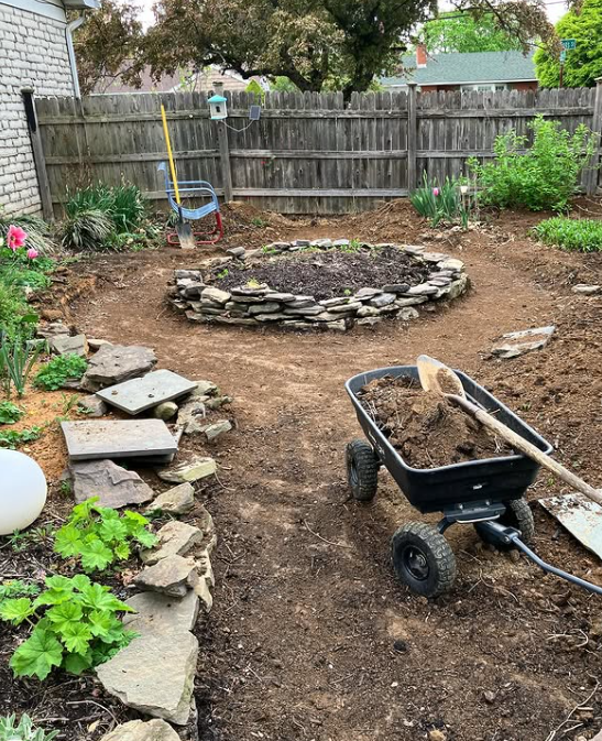 There's the mounded bed, ringed with landscaping rocks found on FB Marketplace (free!). Pathway ready for gravel, thanks to my son's sweat equity, making a level dirt base!