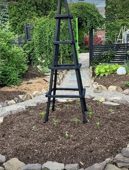 The mound was created to be a focal point that would draw (invited) guests in, and when covered with plants, would also hide the reading nook at the other end. 